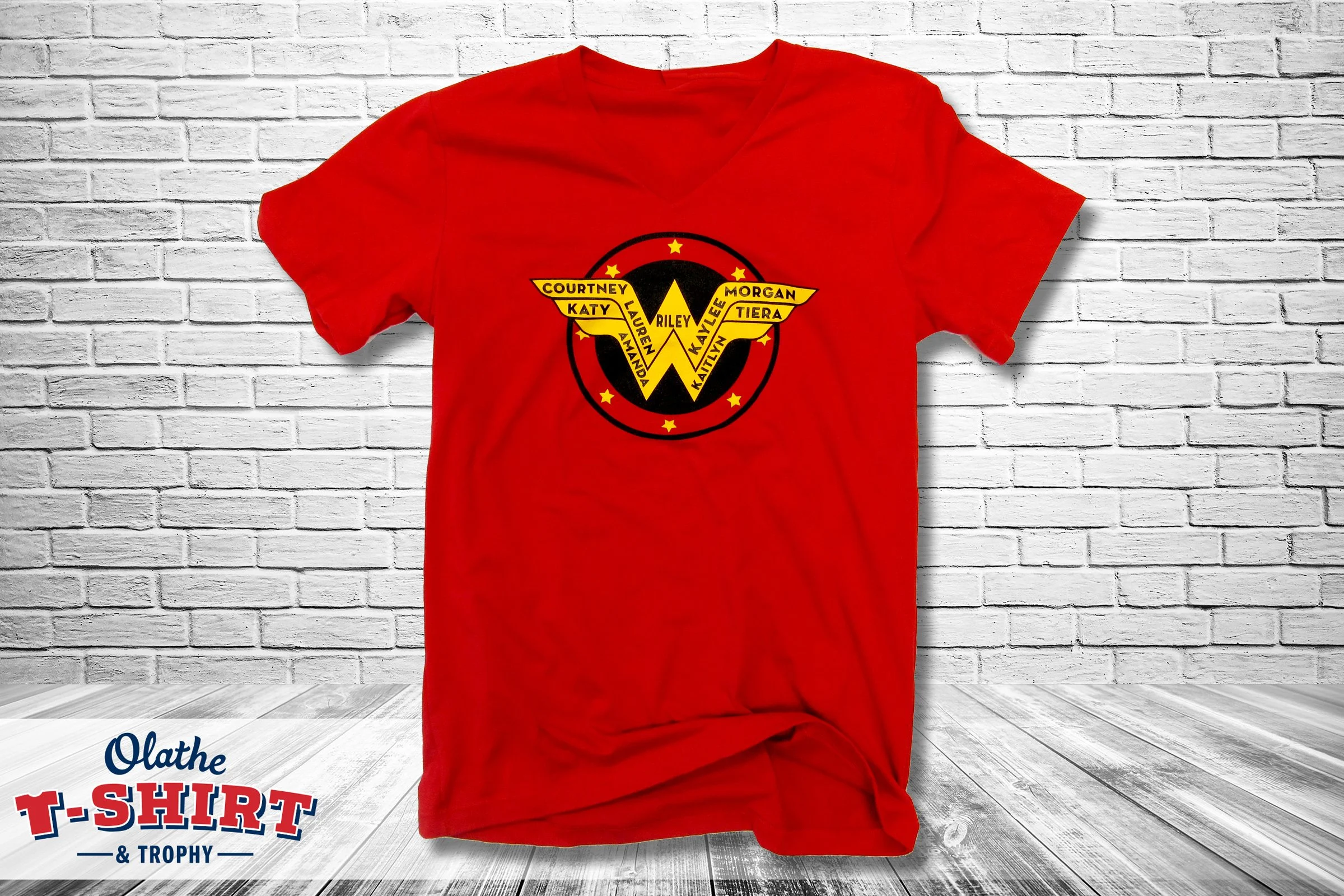 Red shirt with a yellow and black star graphic and decorative lettering.