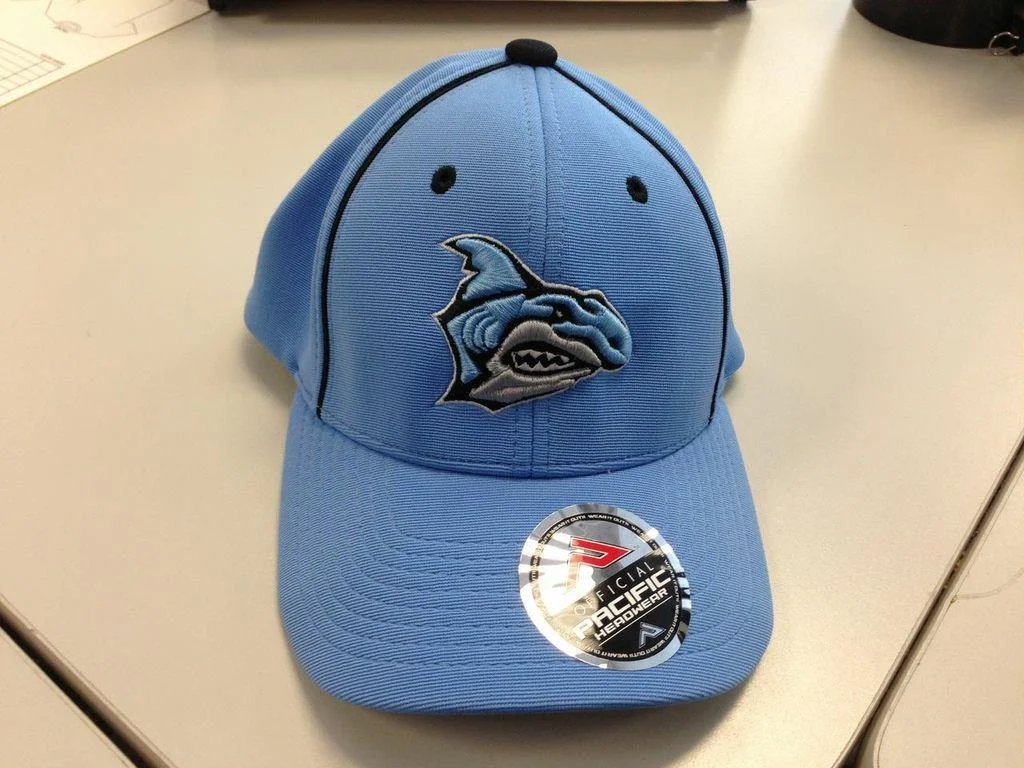 Blue baseball cap with a fish logo on the front and a sticker that reads 'Official Pacific Headwear'.