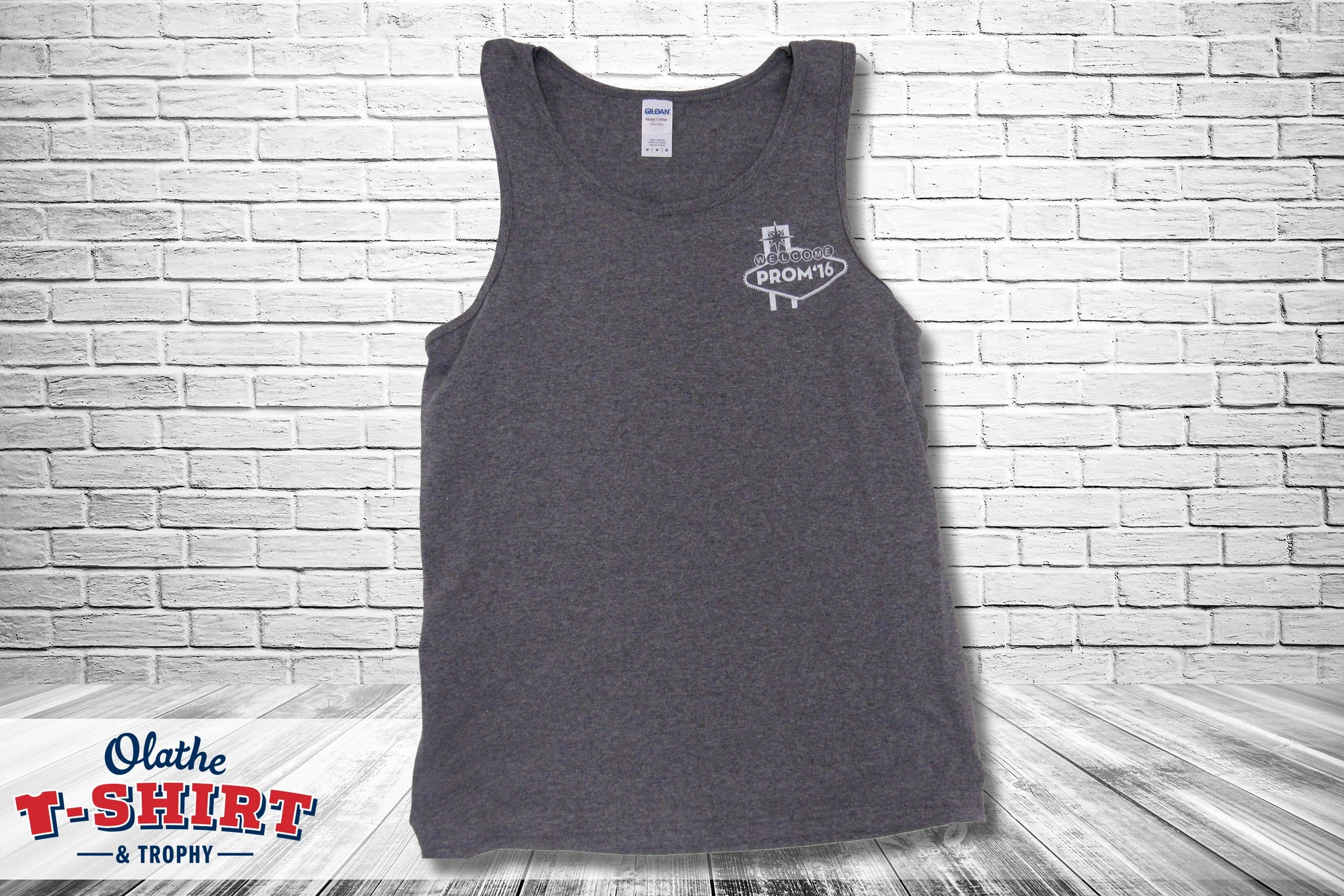 Gray sleeveless T-shirt with white printed design on the left chest area that says "Welcome PROM '16."