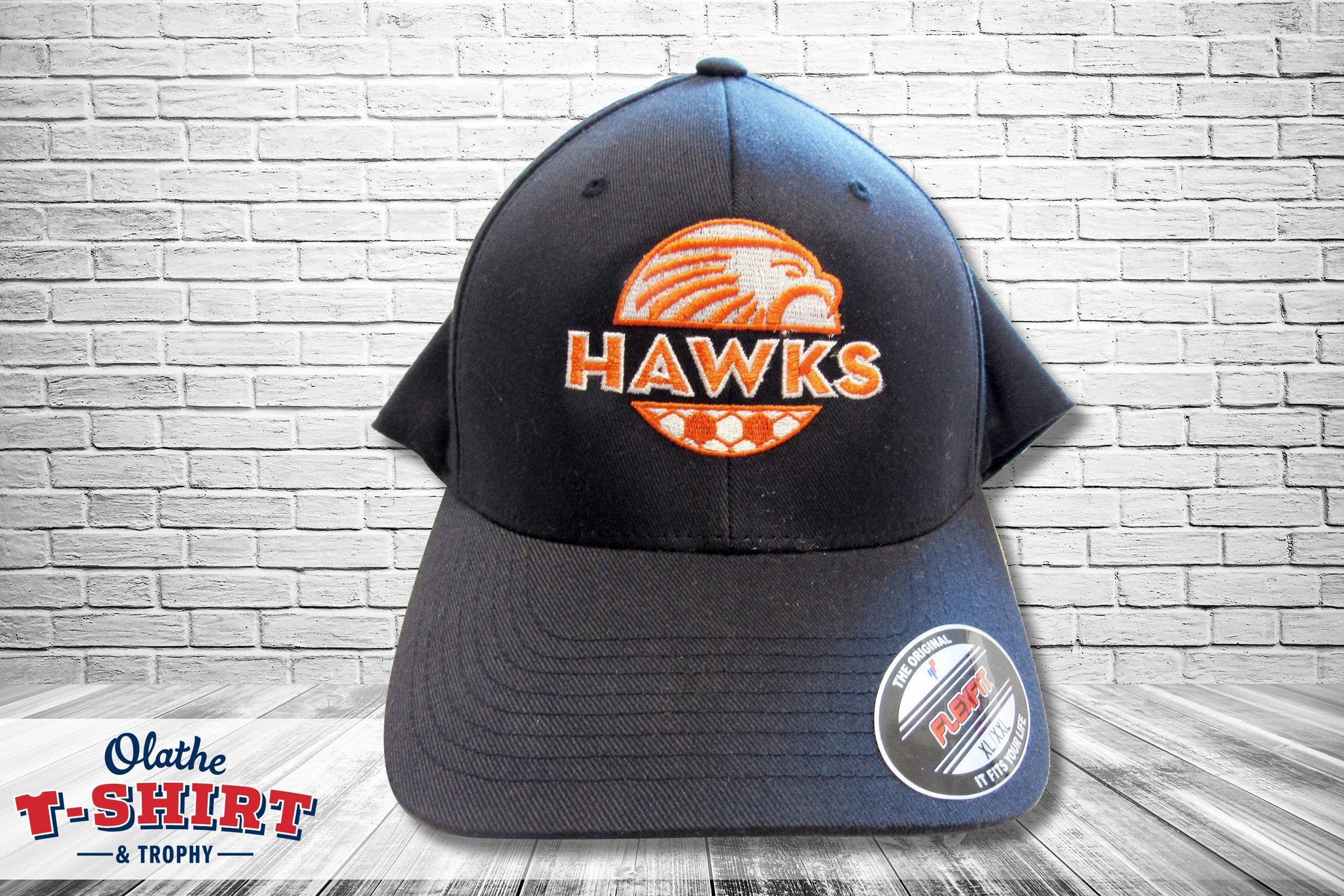 Black Hawks baseball cap with an orange embroidered bird mascot.