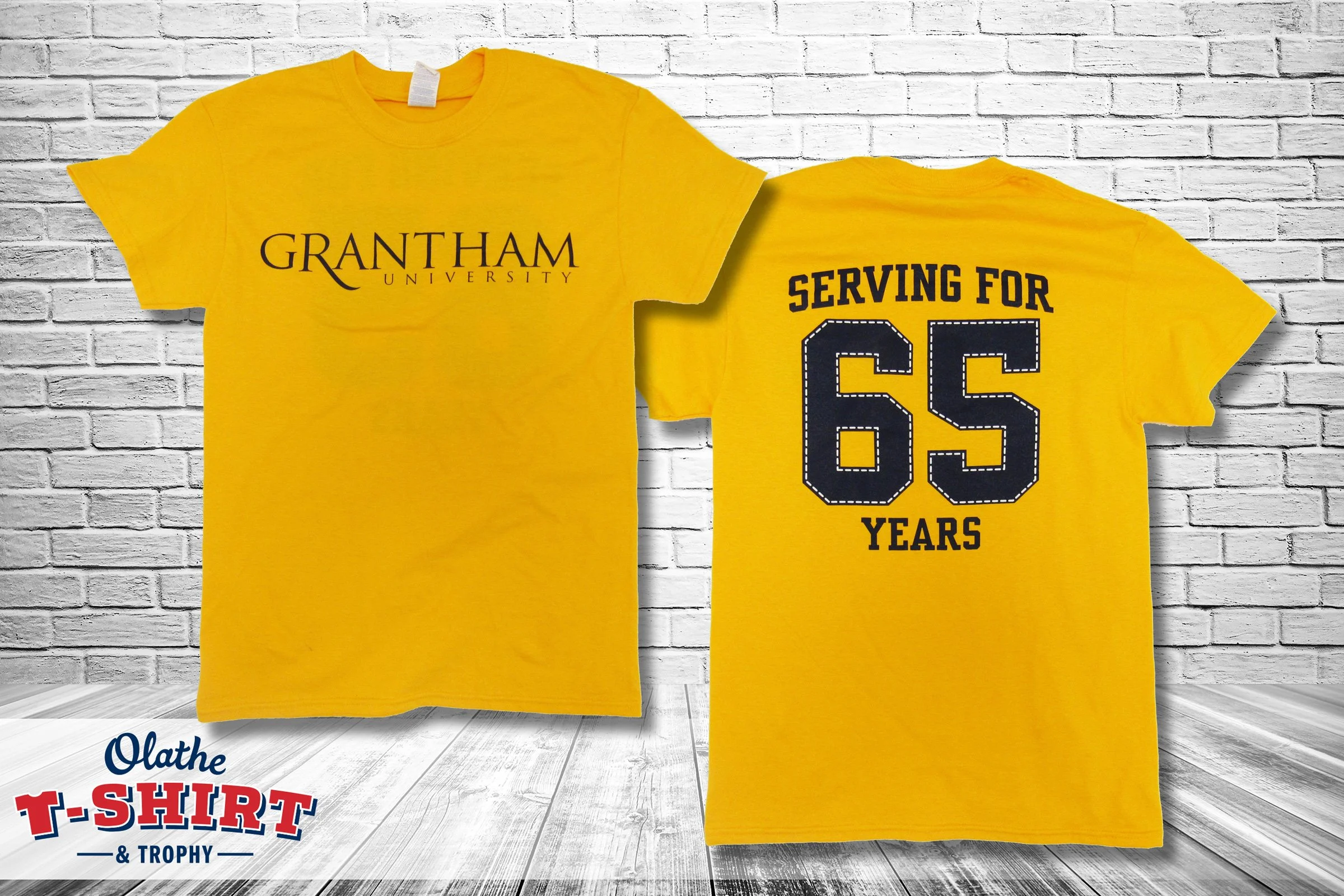Blue Olathe South shirt with a bird mascot and yellow geometric design.