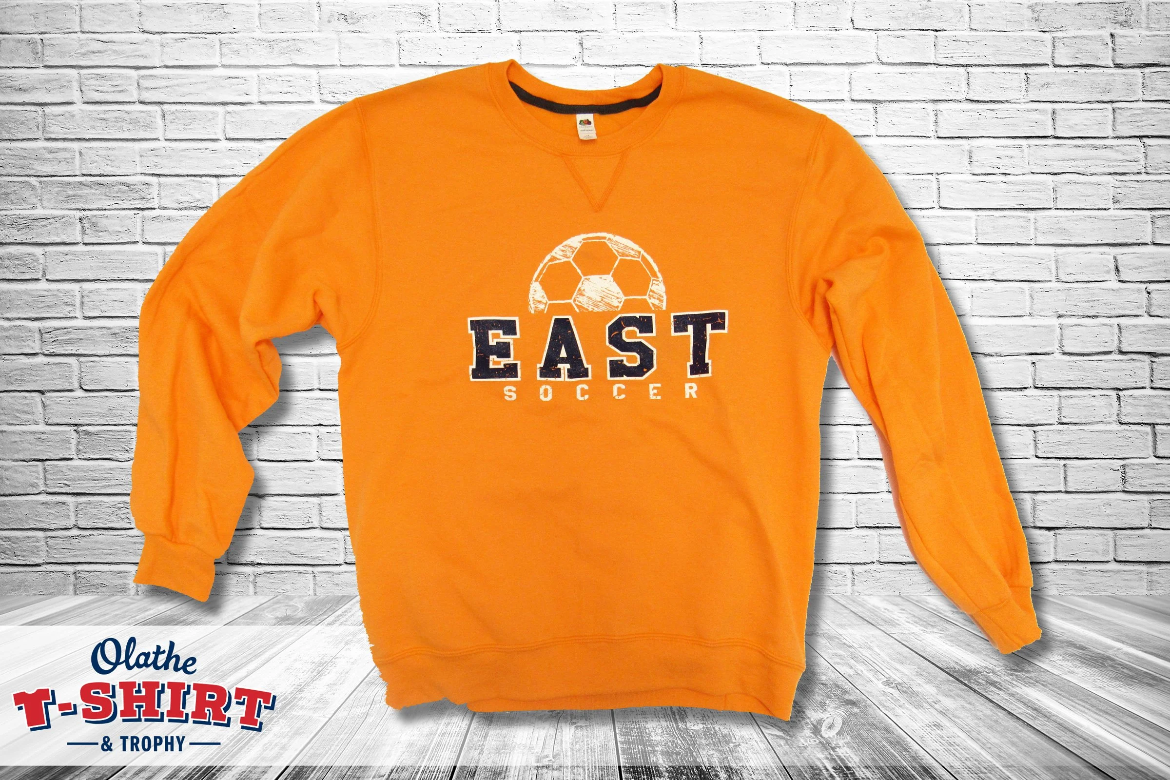 Navy Olathe East Hawks Soccer long-sleeve shirt with chest and sleeve printing.