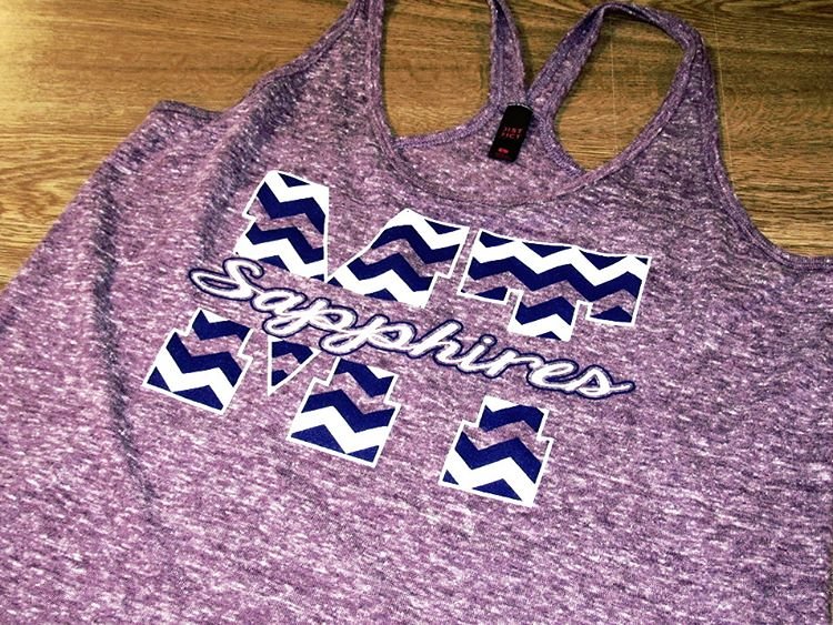 Purple tank top with white script lettering and decorative accents.
