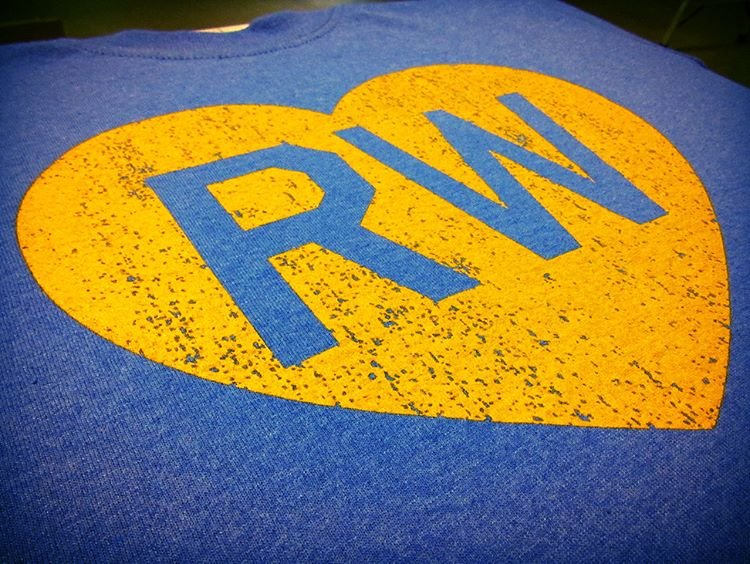 Close-up of a printed horse-head logo with white and blue lettering on dark fabric.