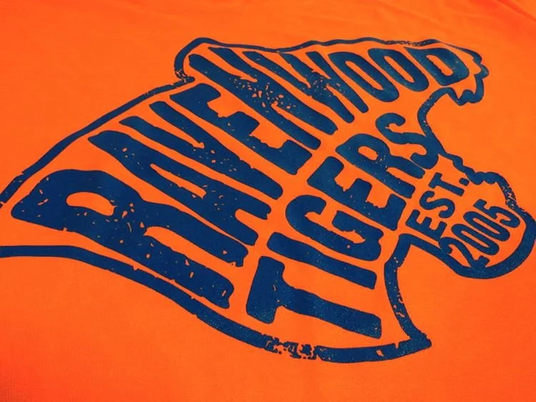 Orange t-shirt with a blue graphic that reads 'Deep Blue Food Truck, Est. 2003' in a stylized fish shape.
