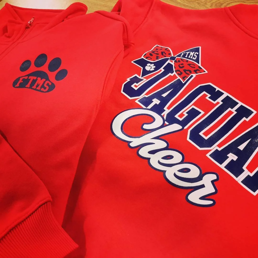 Red hoodie with a paw-print chest design, shown with a coordinating patterned graphic.