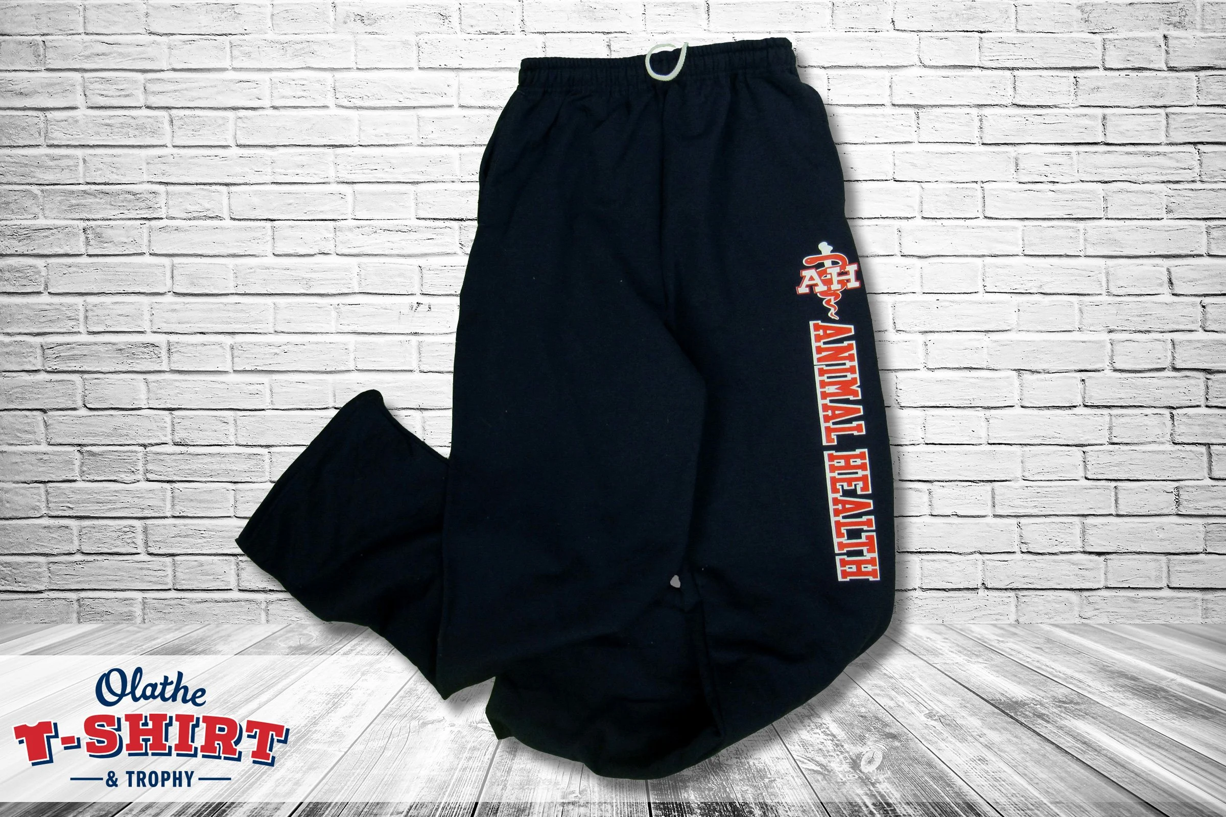 Black sweatpants with red and white lettering down one leg.
