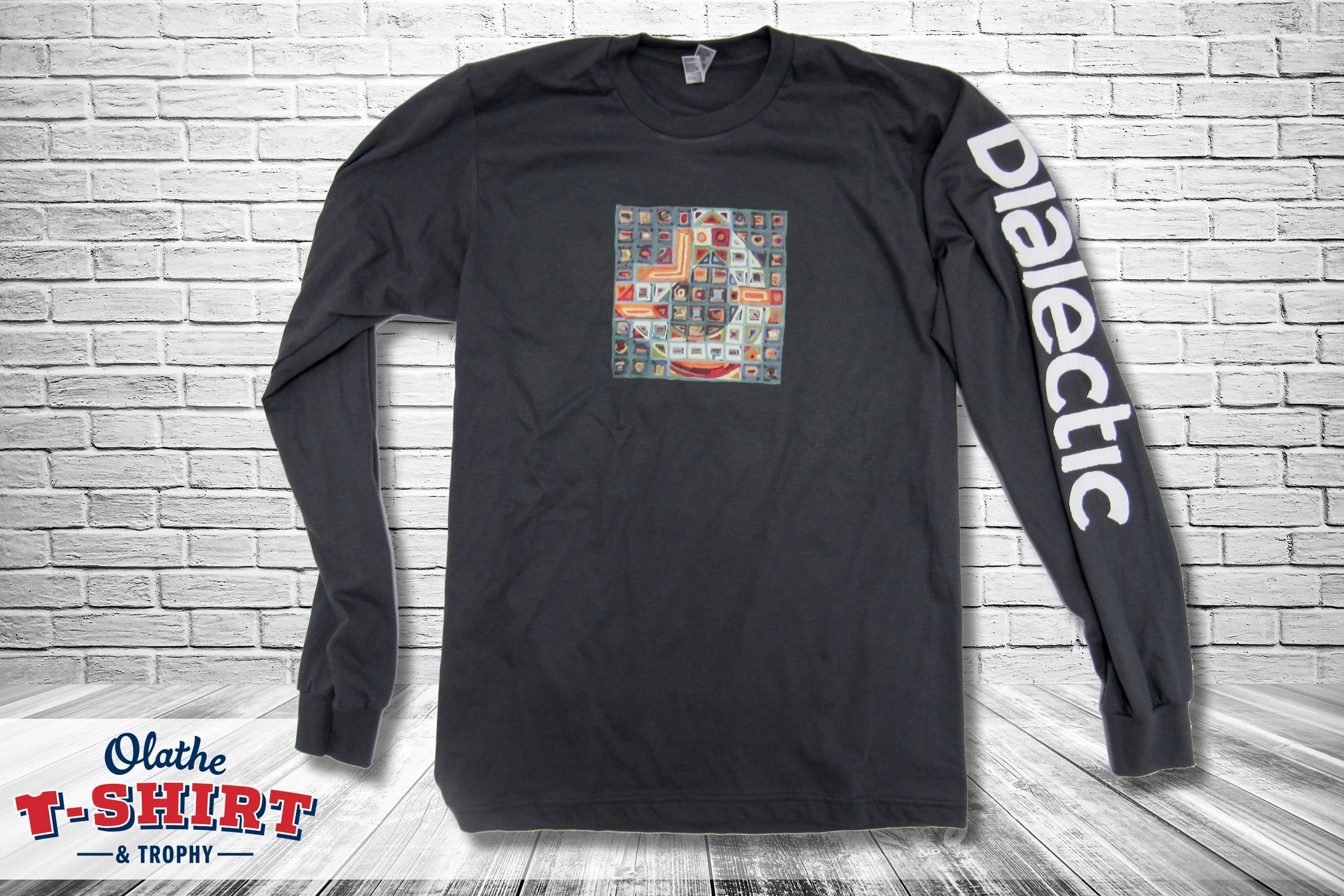 Gray shirt with a large blue heart and school initials.