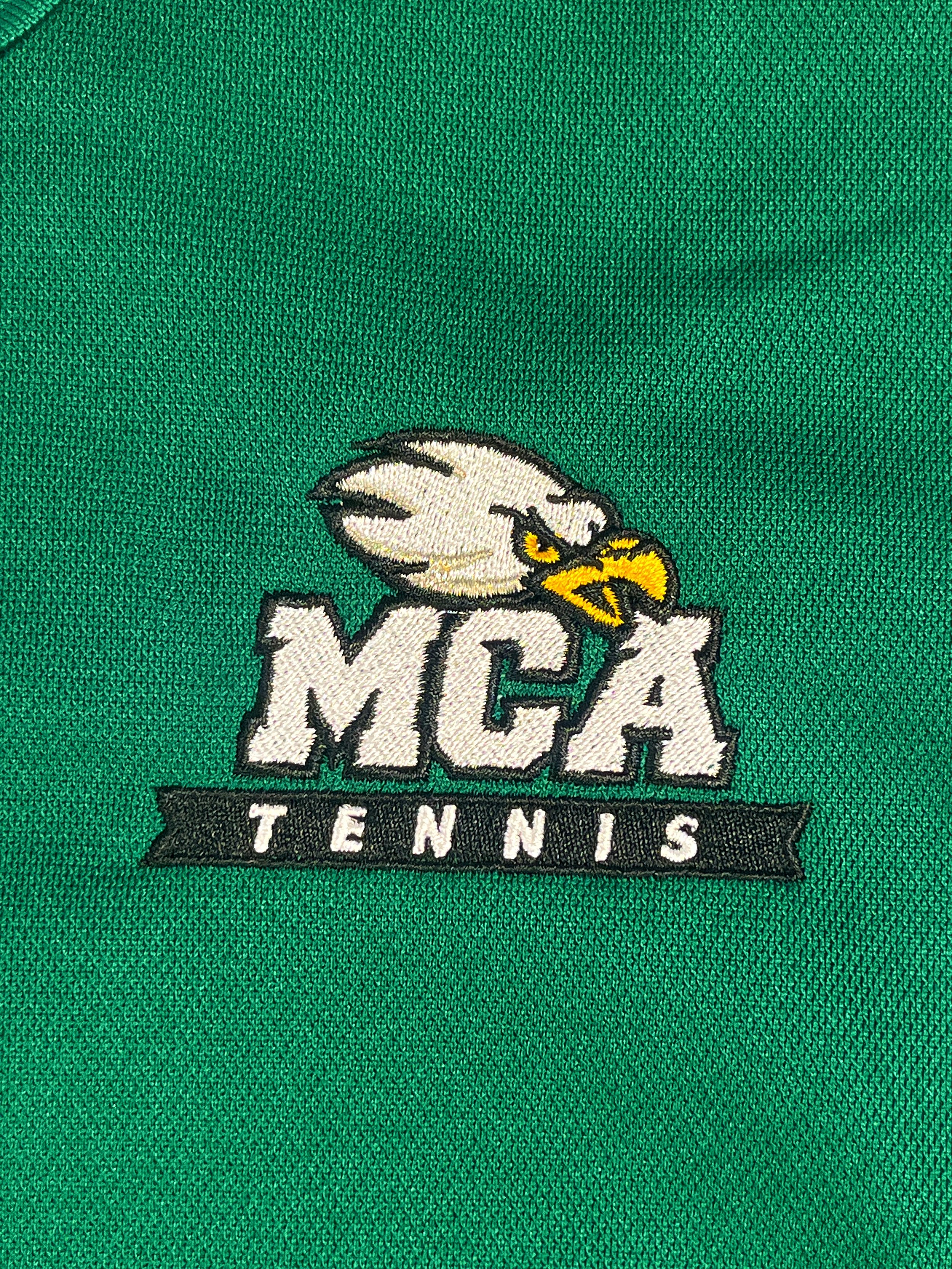 Close-up of a tennis mascot logo embroidered on green fabric.