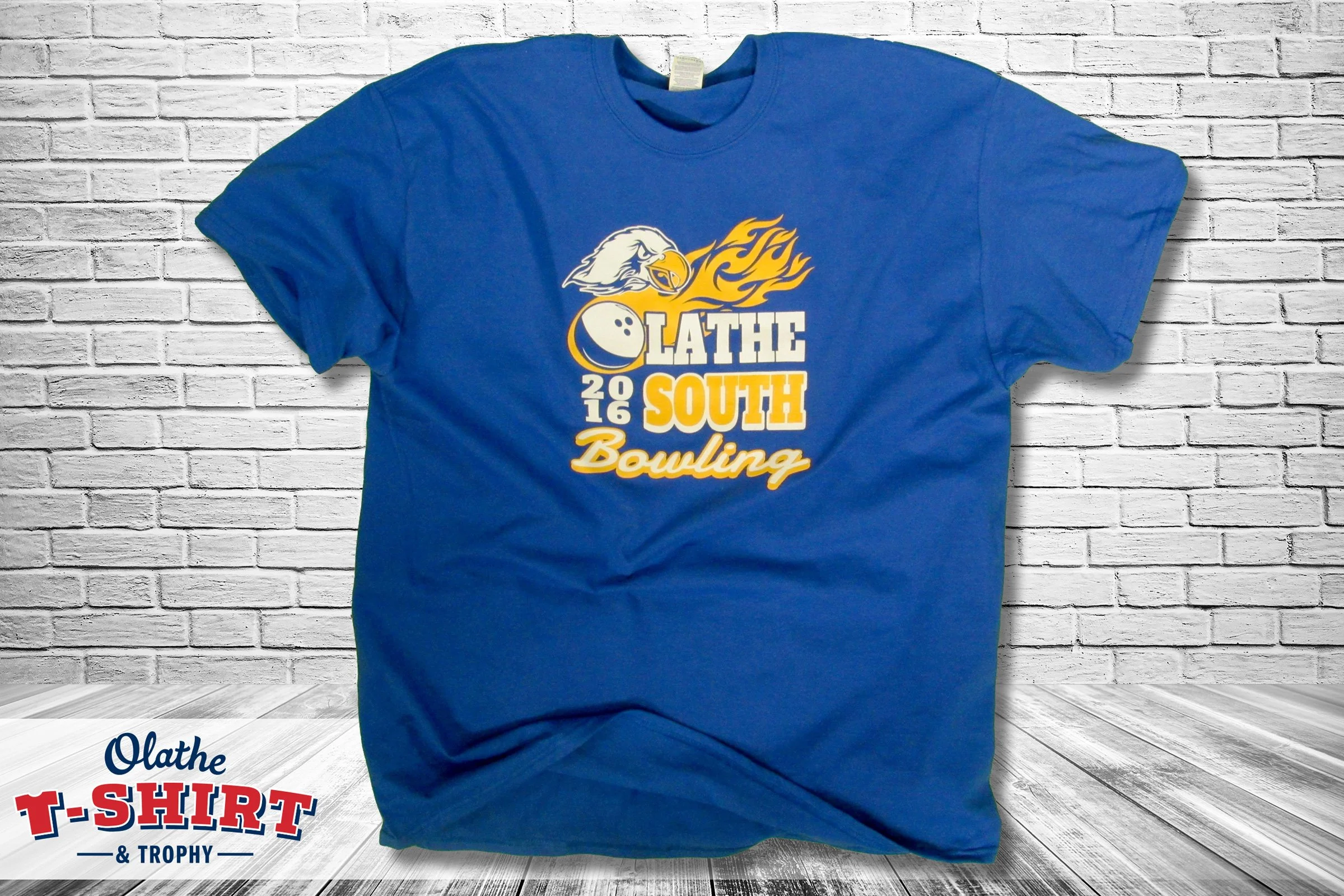 Blue Olathe South bowling shirt with a bird mascot and bowling-ball graphic.