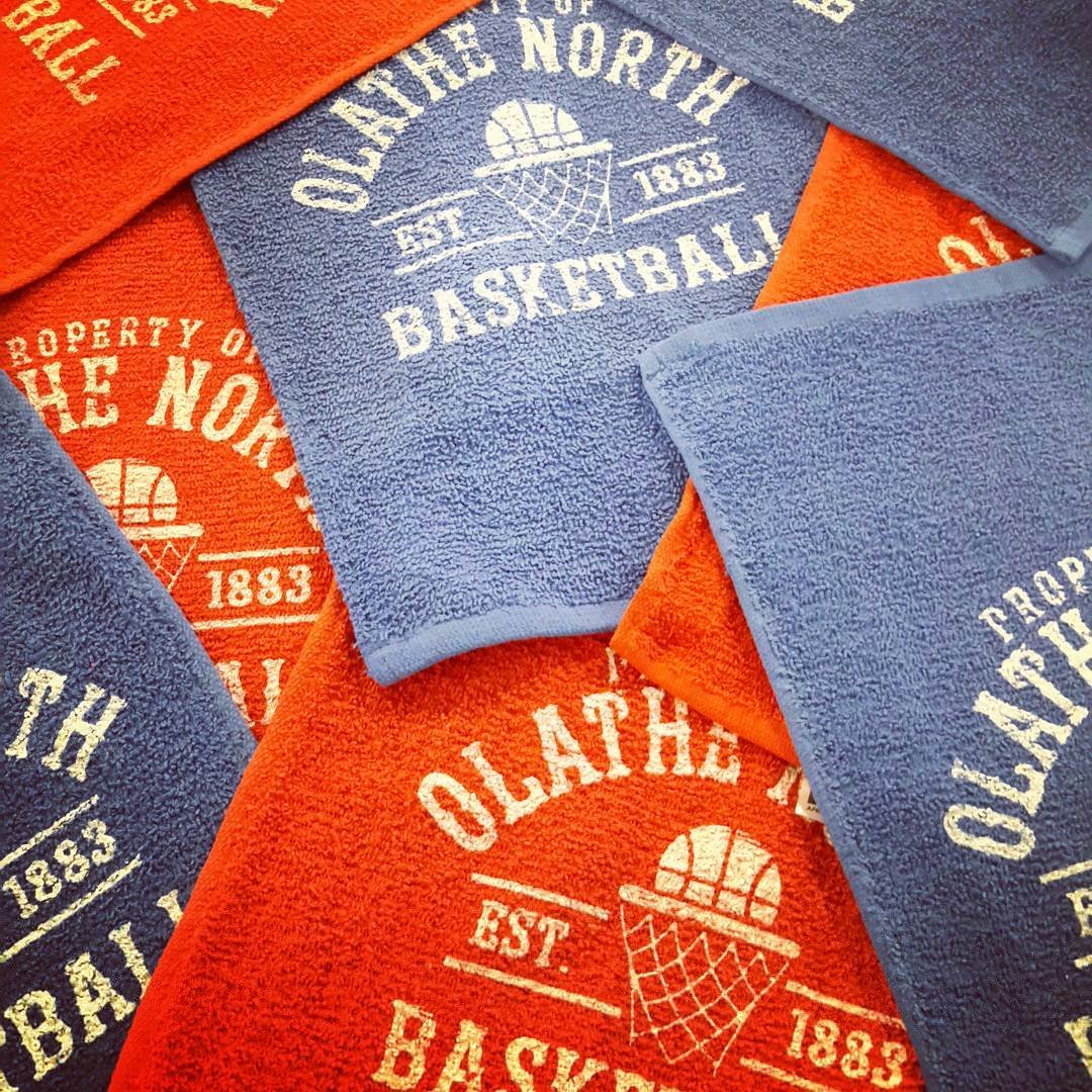 Close-up of blue and orange basketball graphics printed on fabric.