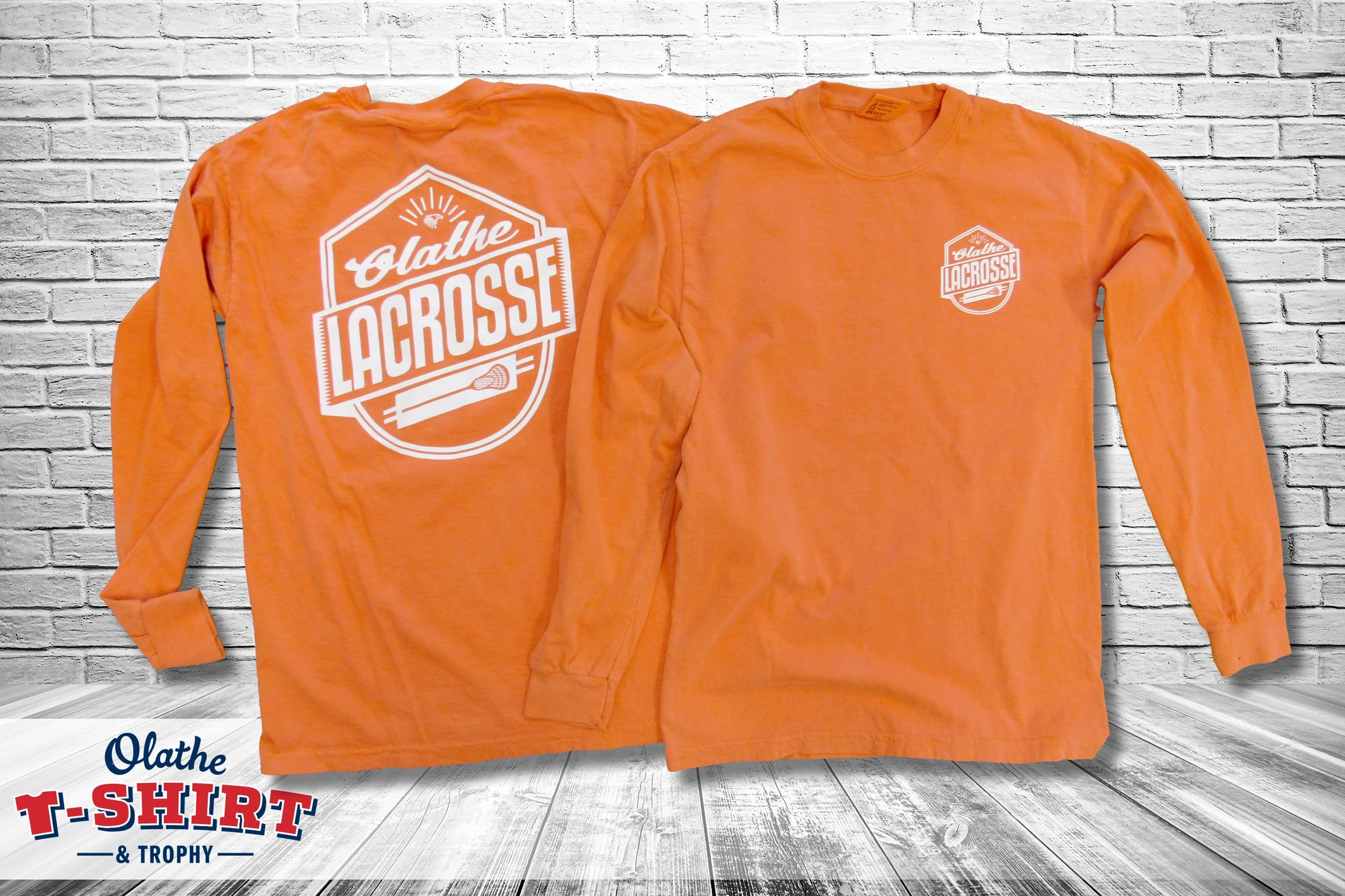 Orange long-sleeve lacrosse shirt with a white chest graphic.