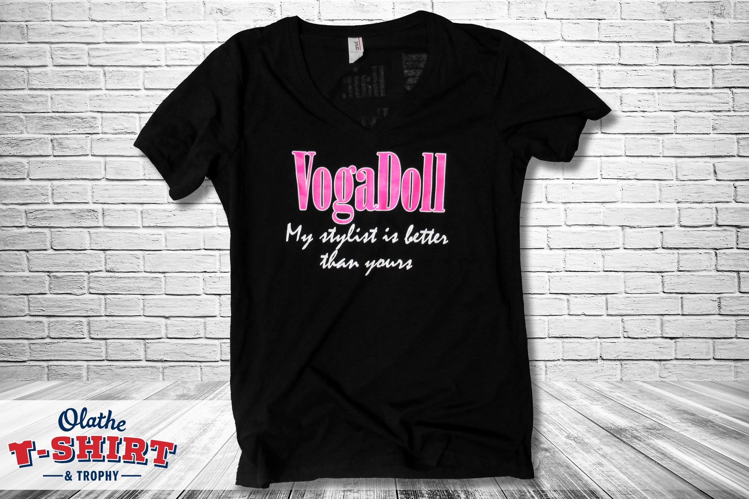 Black shirt with pink and white salon-themed lettering.