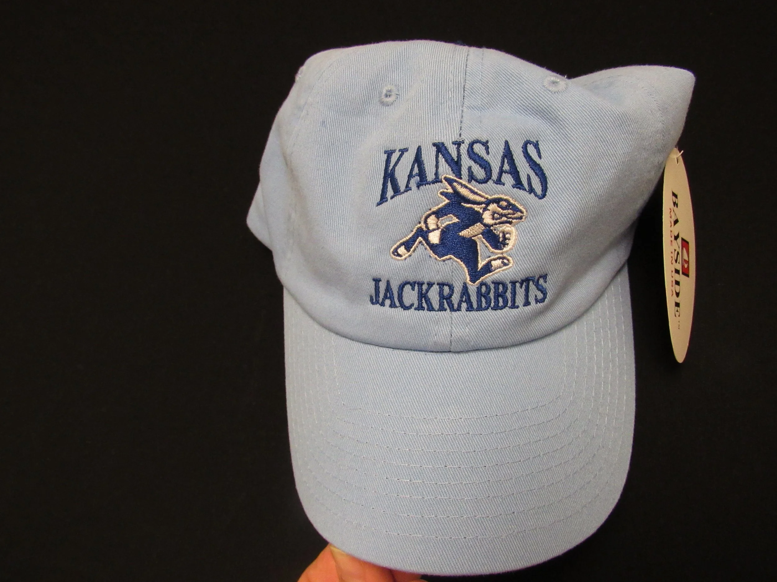 Light-colored baseball cap with an embroidered bird mascot.