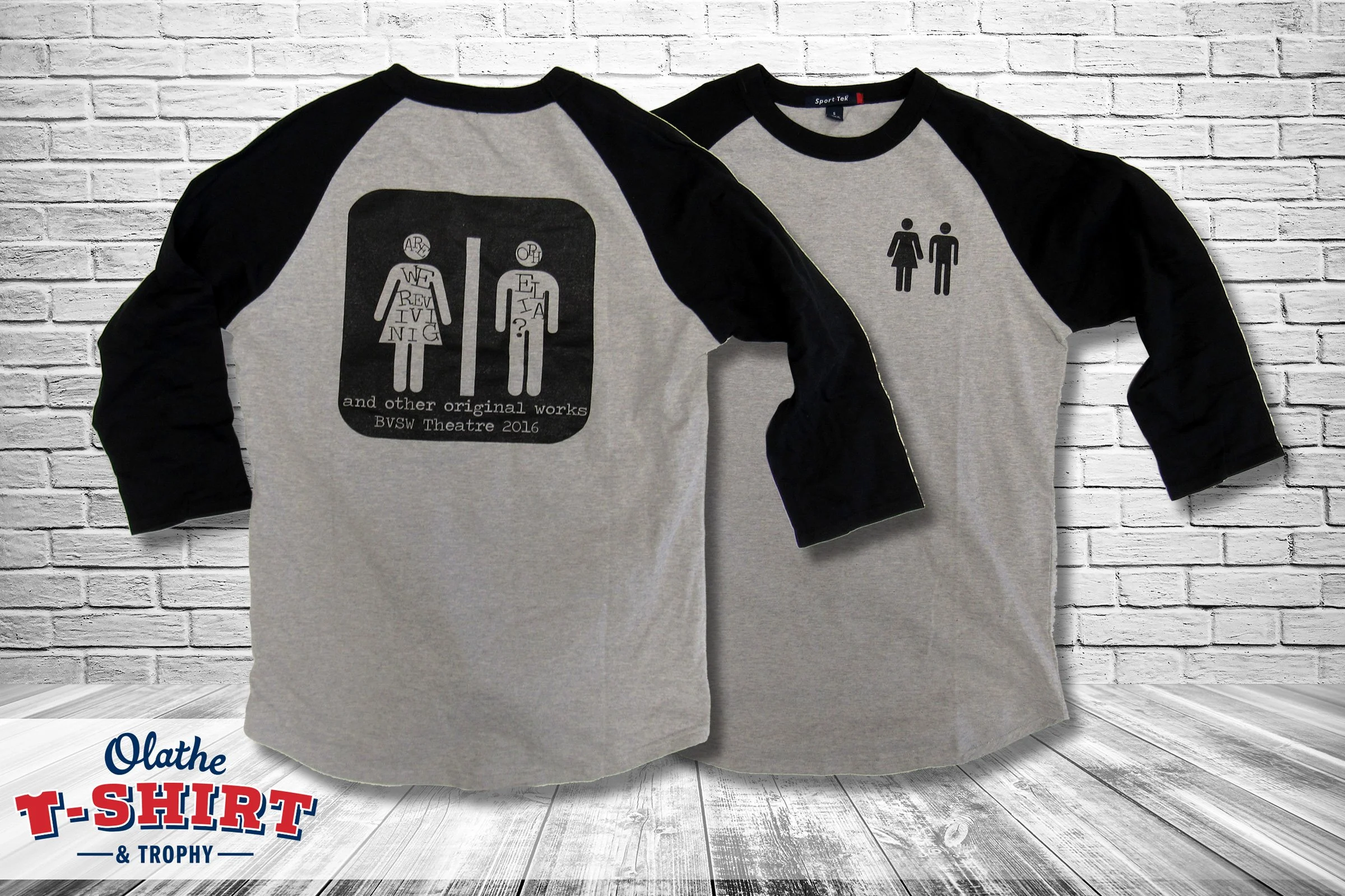 Front and back of gray and black theater shirts with illustrated figures and lettering.