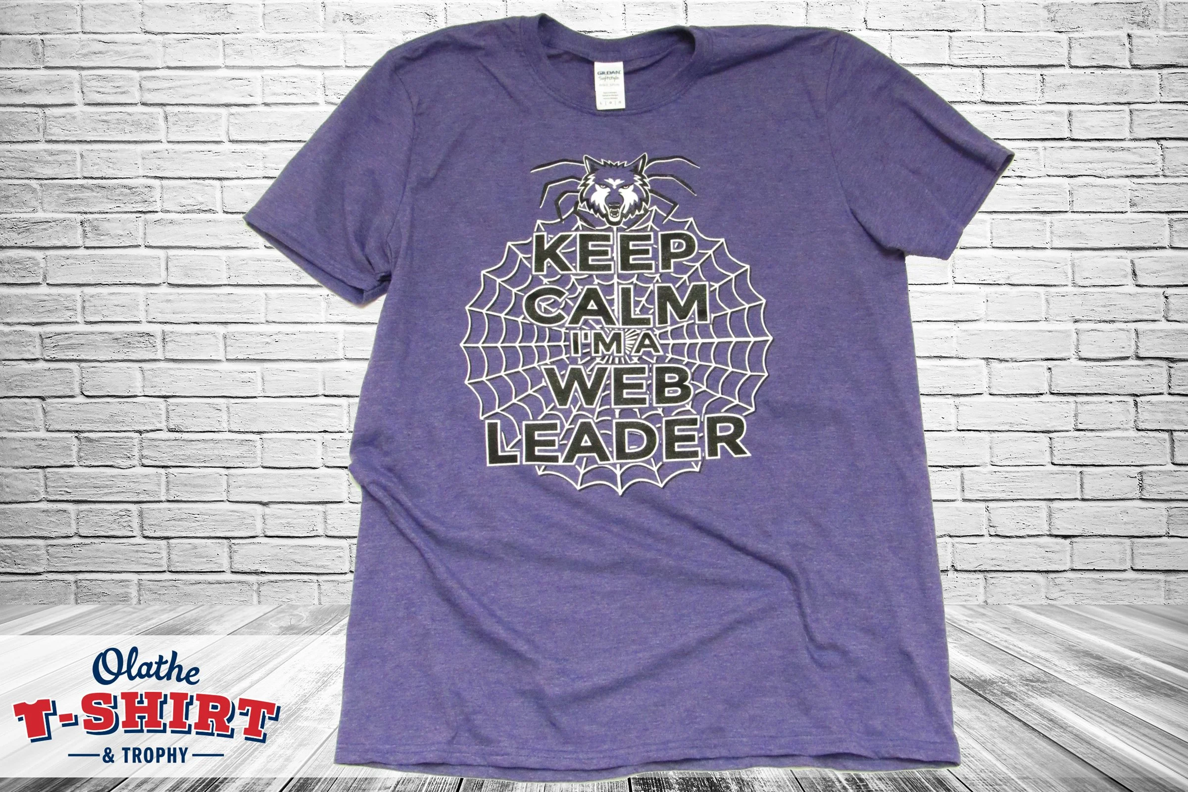 Purple WEB leader shirt with a mascot and spiderweb design.