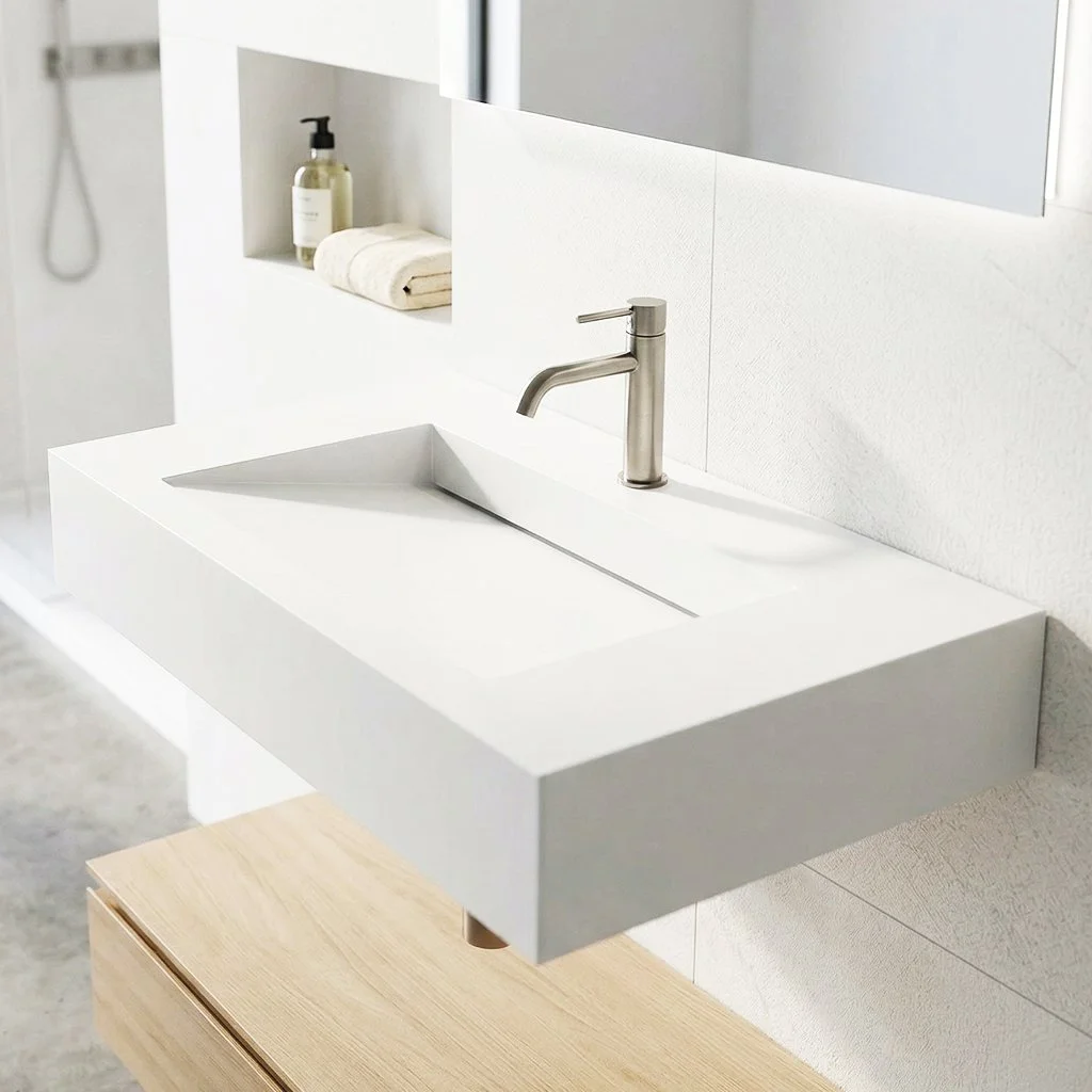 A modern bathroom sink with a stainless steel faucet, a bottle of liquid soap, a rolled white towel, and a mirror mounted above the sink.