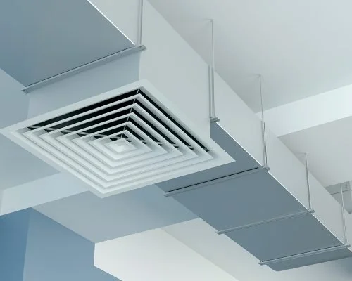 Ceiling with a large white air vent and ductwork.