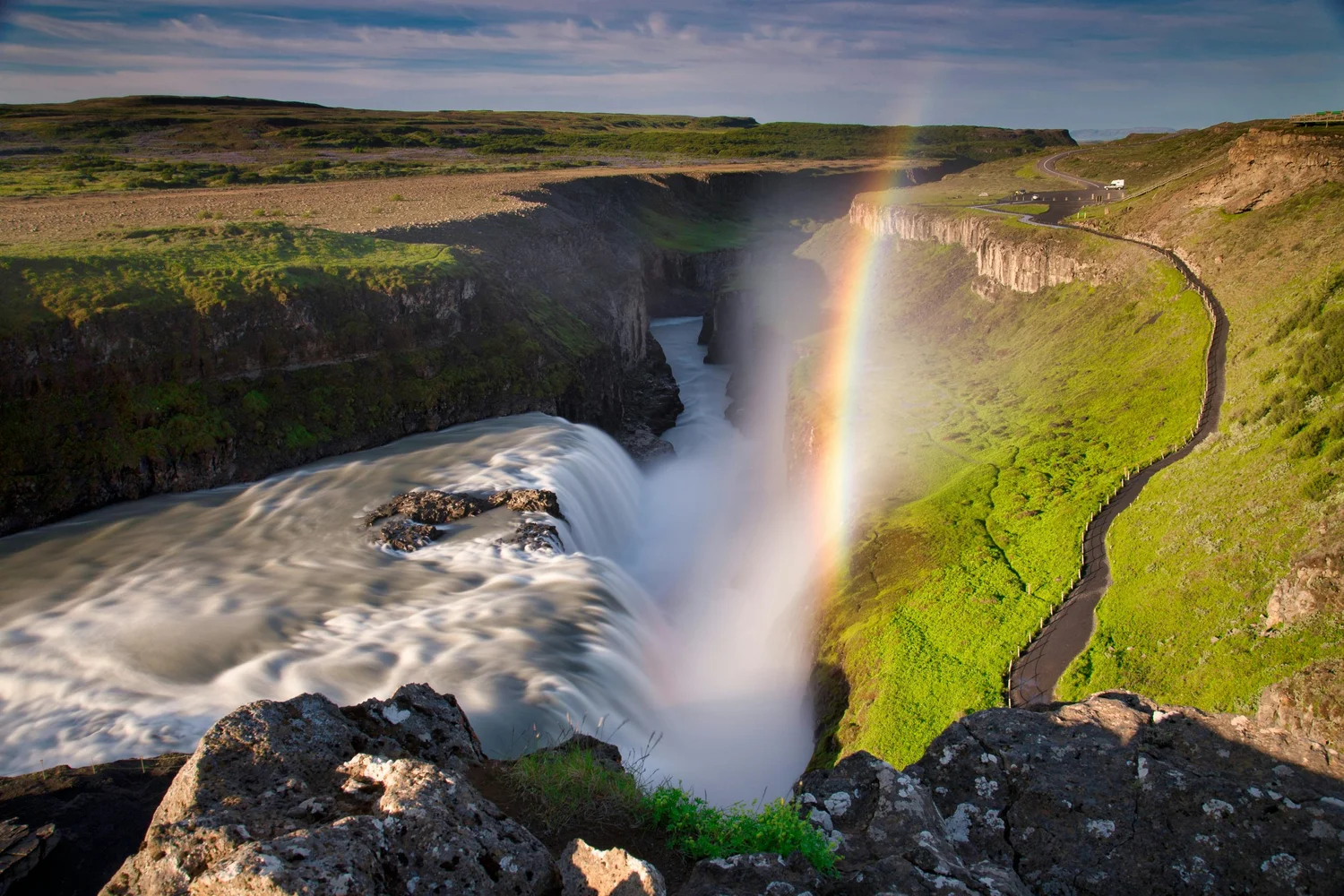 Gullfoss waterfall plunging into a dramatic canyon beneath a rainbow