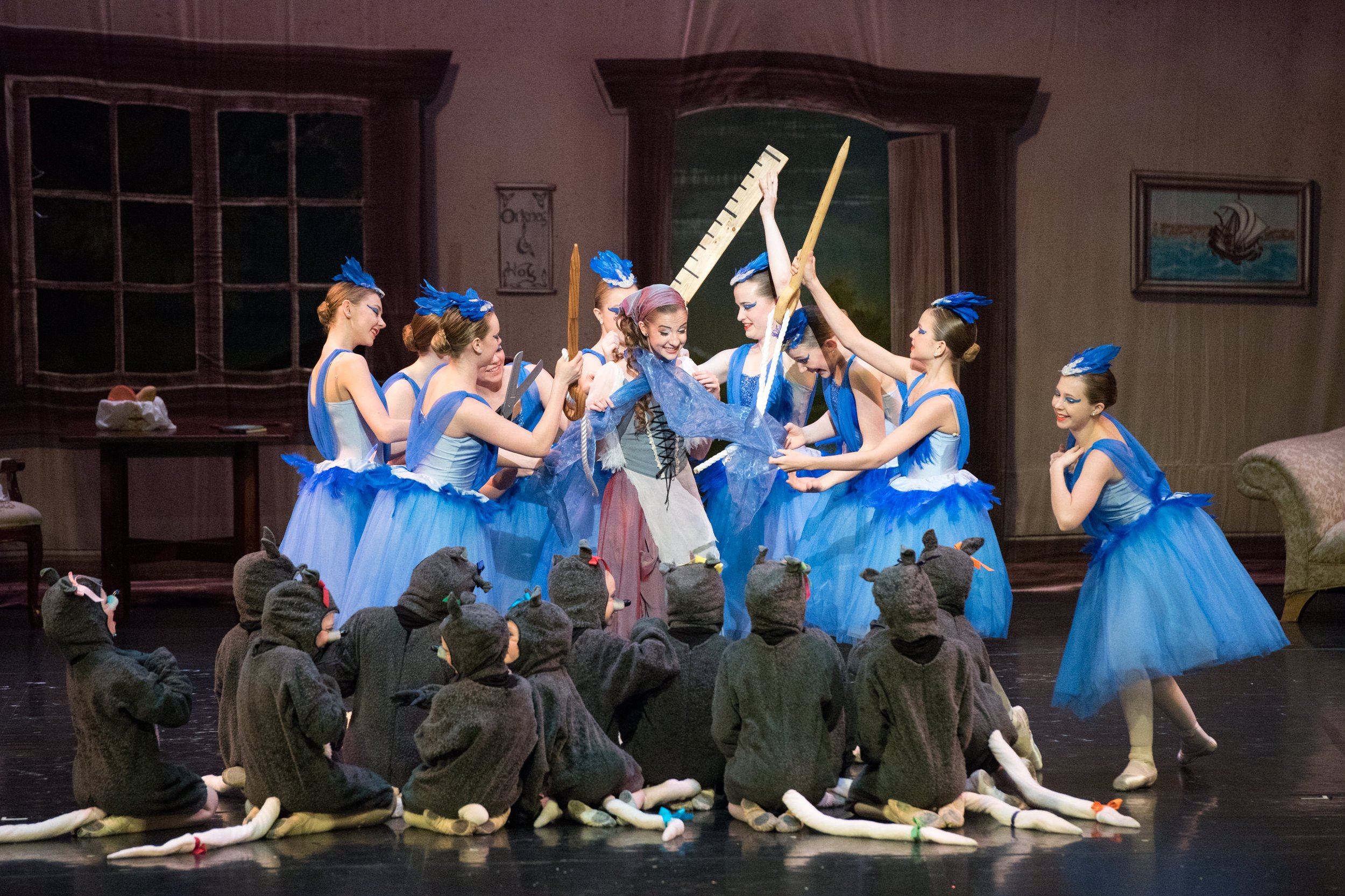 Ballet performance with dancers in blue tutus and mice costumes on stage.