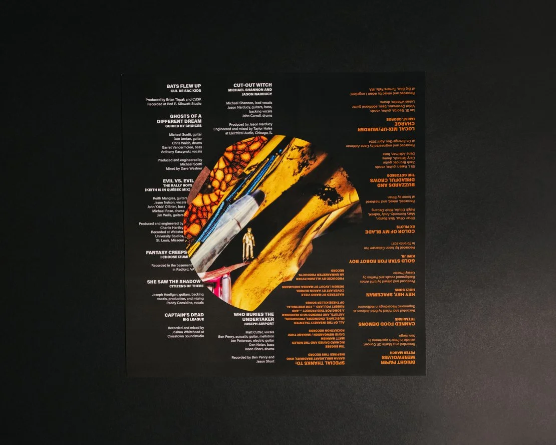 Insert artwork for an album featuring a black background with an illustrative abstract design in the center. The title track text can be read from either direction.