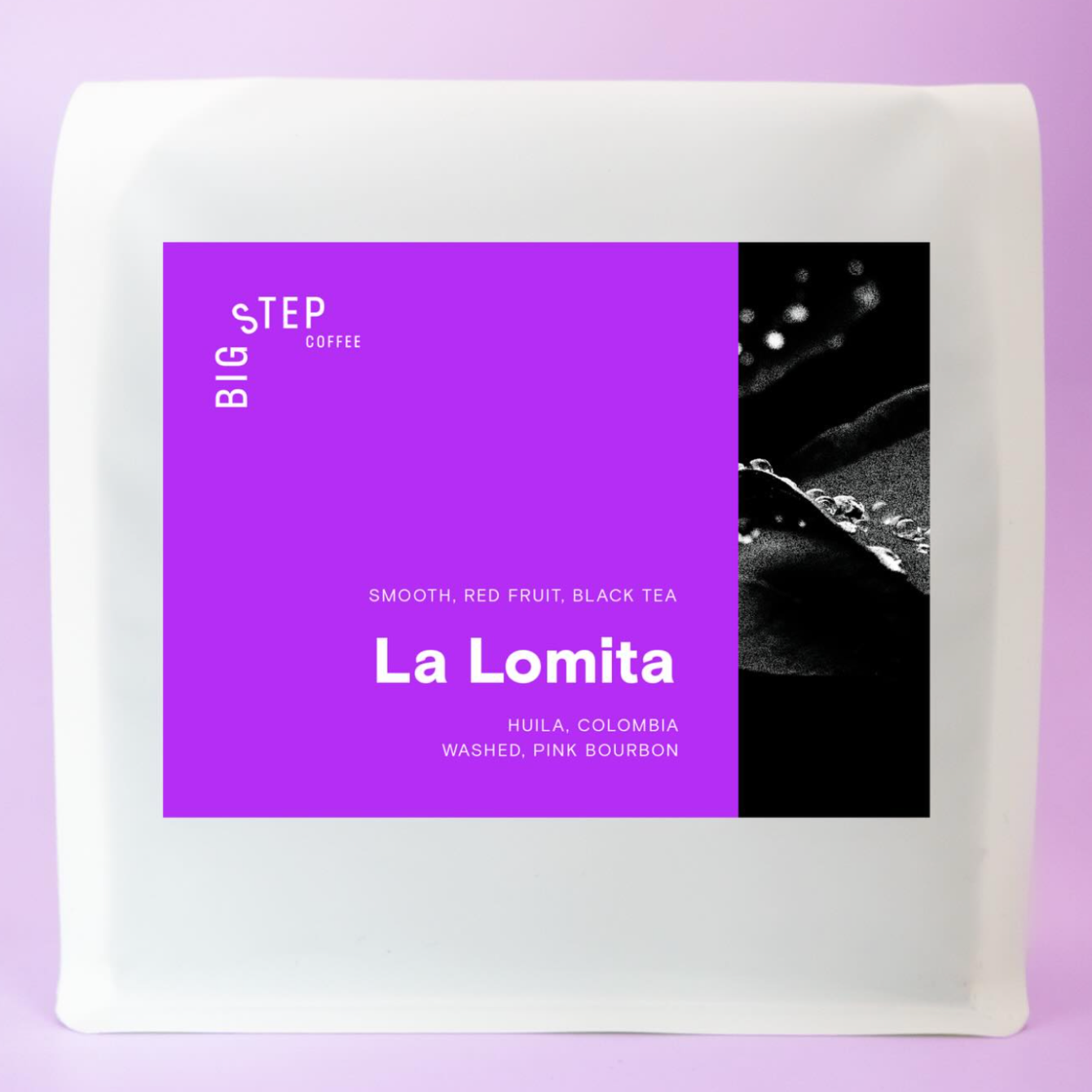 Package of La Lomita coffee with a purple label, black and white abstract design, and text indicating smooth, red fruit, black tea flavor.