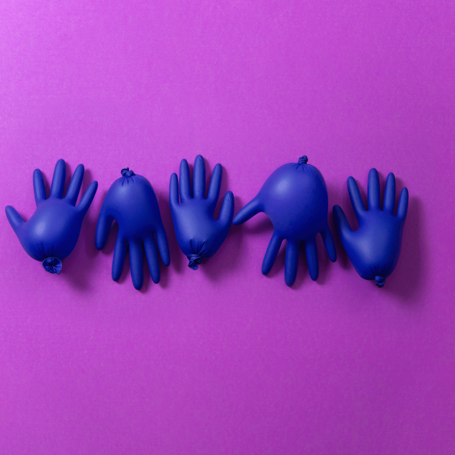 Five blue deflated balloons shaped like hands, lined up on a purple background.