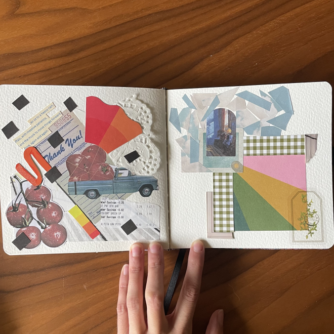 Open scrapbook with various decorative paper cutouts, with visuals like small cherries, and a toy pickup truck on a wooden table.