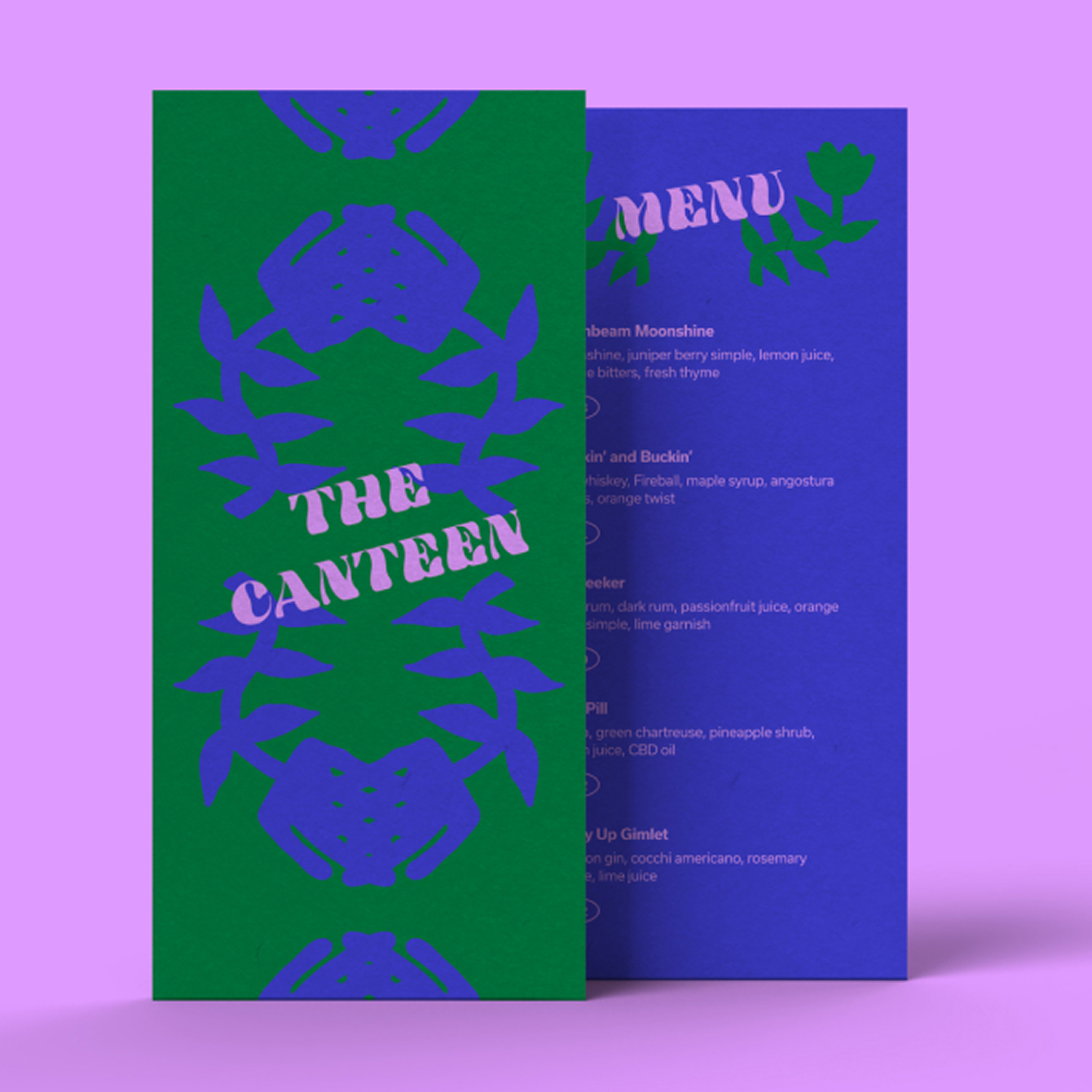 A colorful menu with a green front cover displaying the words "The Canteen" and a purple floral design. The back of the menu is visible, showing the menu items and ingredients on a blue background.