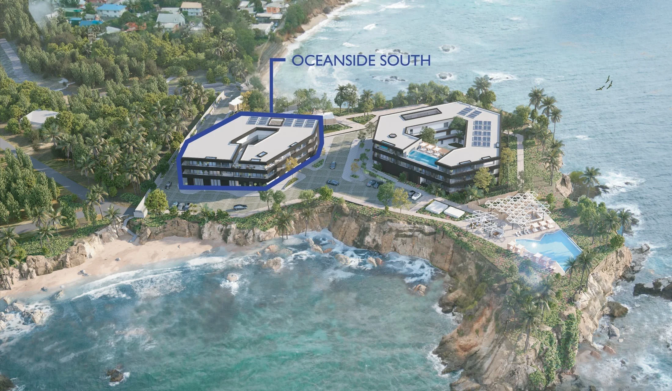 Aerial view of resort with two modern buildings sitting on a rocky peninsula. One building outlined with text label Oceanside South.