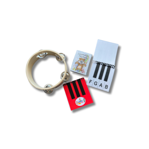 A tambourine, two flashcards with musical notes and letters, a small package with a lion illustration, and a colorful round sticker.