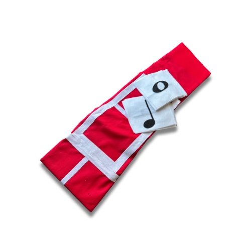 Red towel with white music note and eye graphic design on a black background.