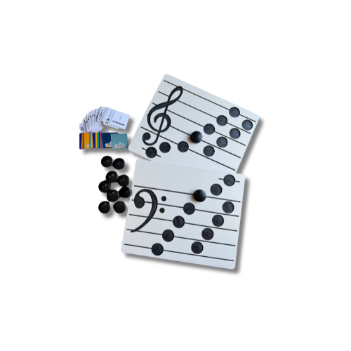 Educational musical set with staff paper, black marbles, and colored booklets on a black background.