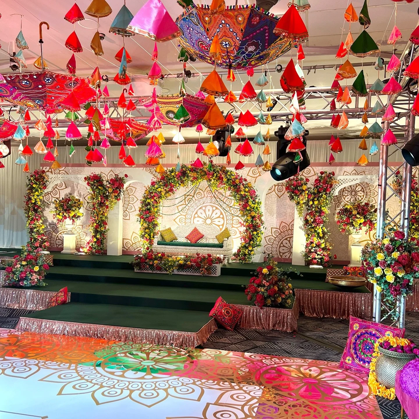 Who says a venue can&rsquo;t be transformed into something spectacular? 🌟 With vibrant floral arches, a dazzling mandala backdrop, and a custom-printed dance floor that ties it all together, we turned a simple space into a Mehndi wonderland! Add in 