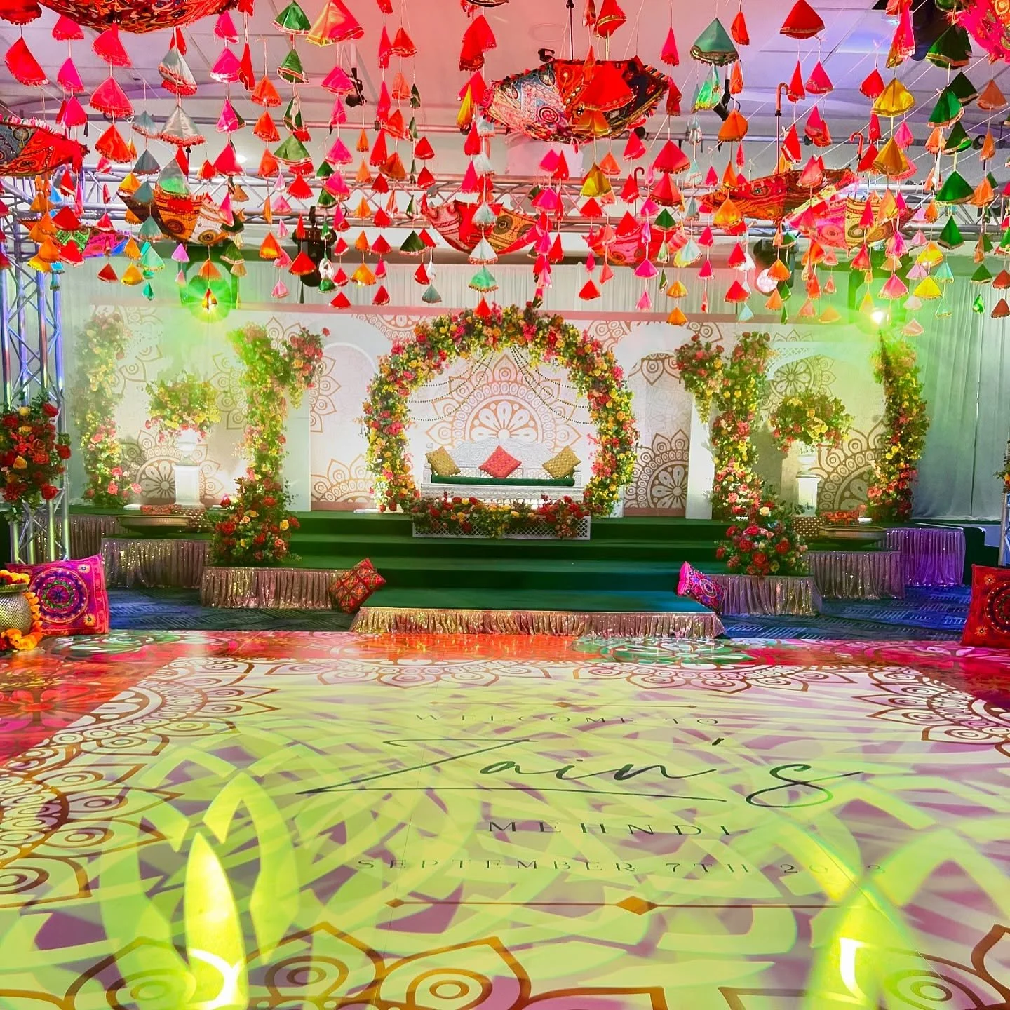 Who says a venue can&rsquo;t be transformed into something spectacular? 🌟 With vibrant floral arches, a dazzling mandala backdrop, and a custom-printed dance floor that ties it all together, we turned a simple space into a Mehndi wonderland! Add in 
