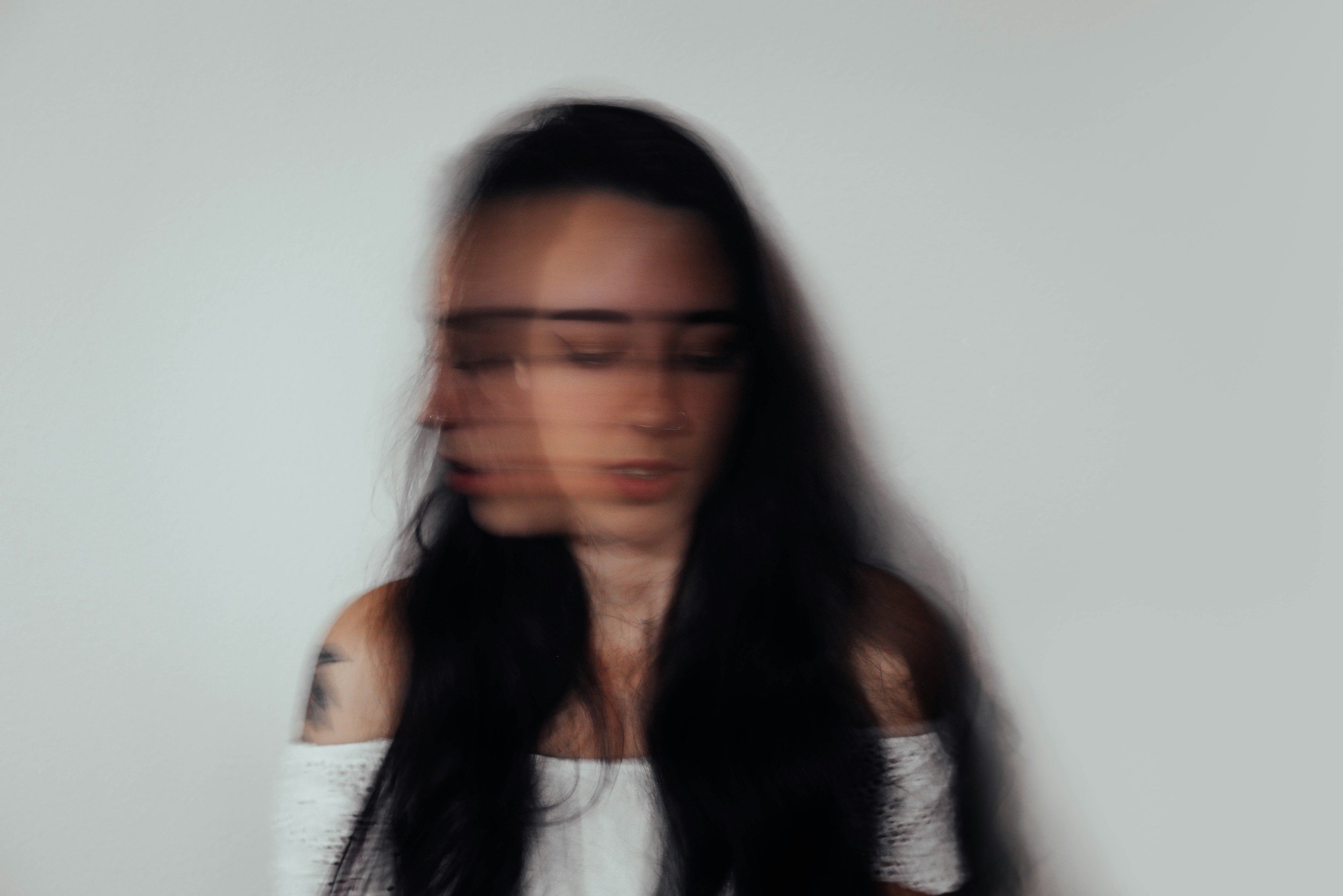 woman with dark hair moving her head quickly | therapy for anxiety in Philadelphia
