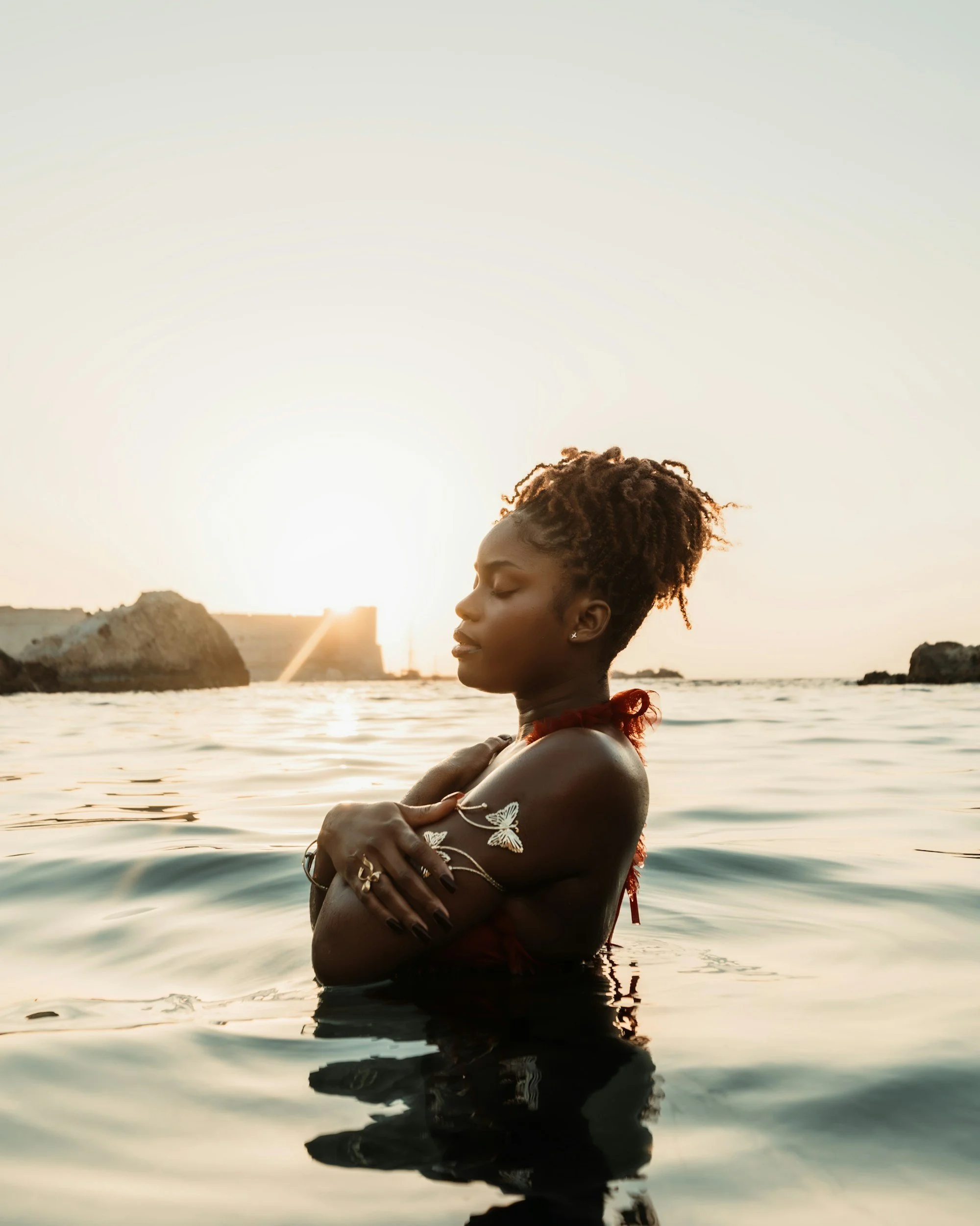woman with eyes closed embracing herself in water | emdr phase 2 therapy in pennsylvania and tennessee