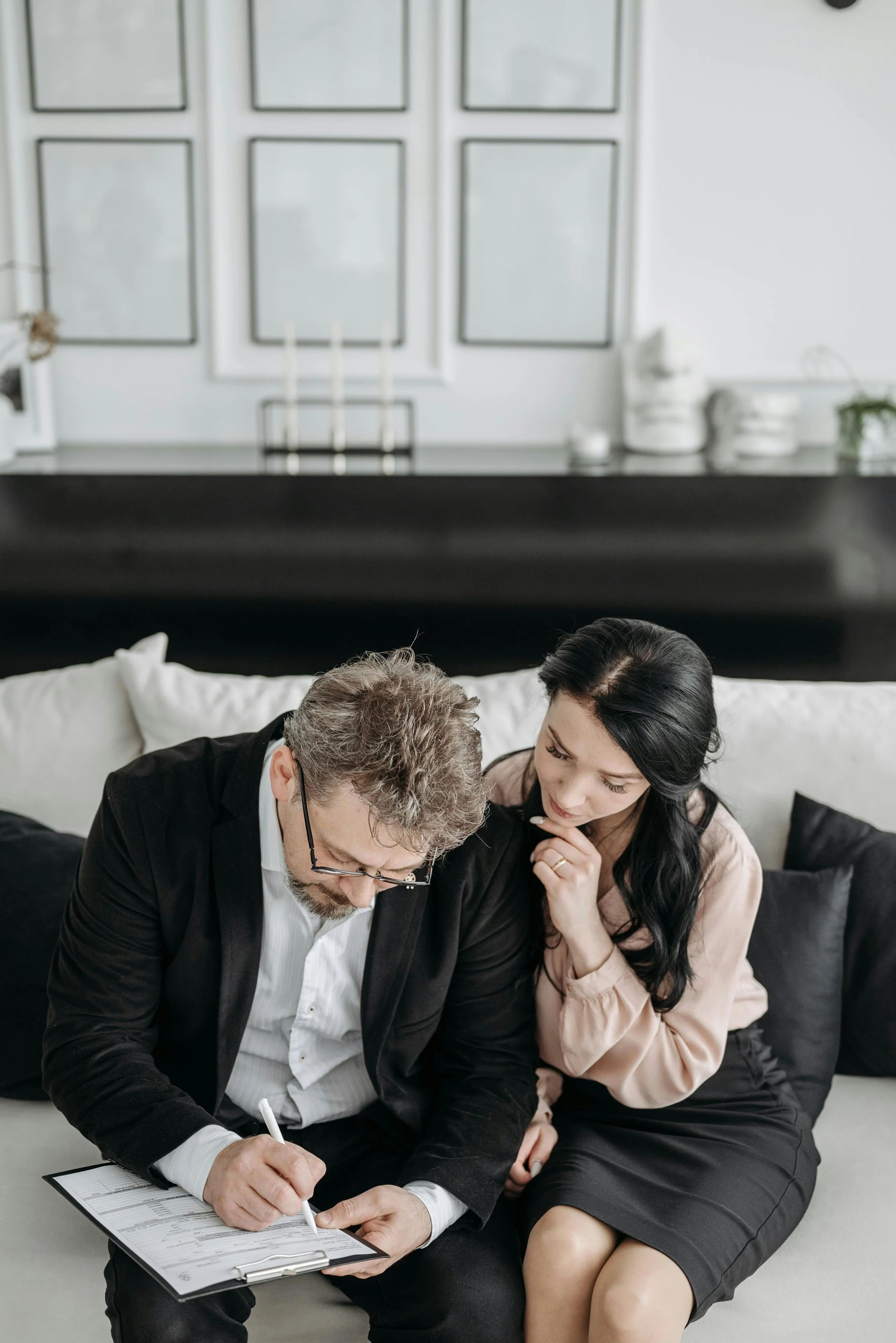 two adults reading a document