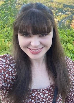 an image of Kelly Hughes smiling at the camera