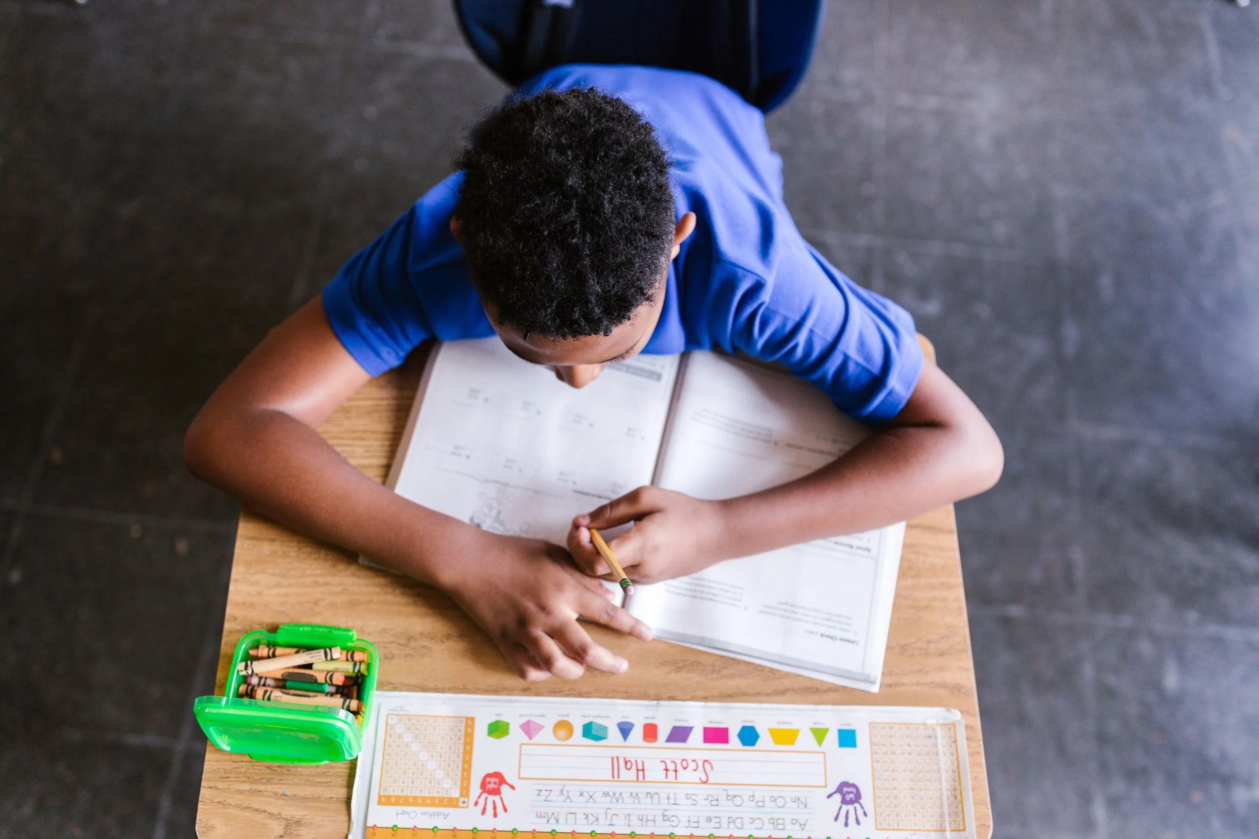 a child writing on the desk