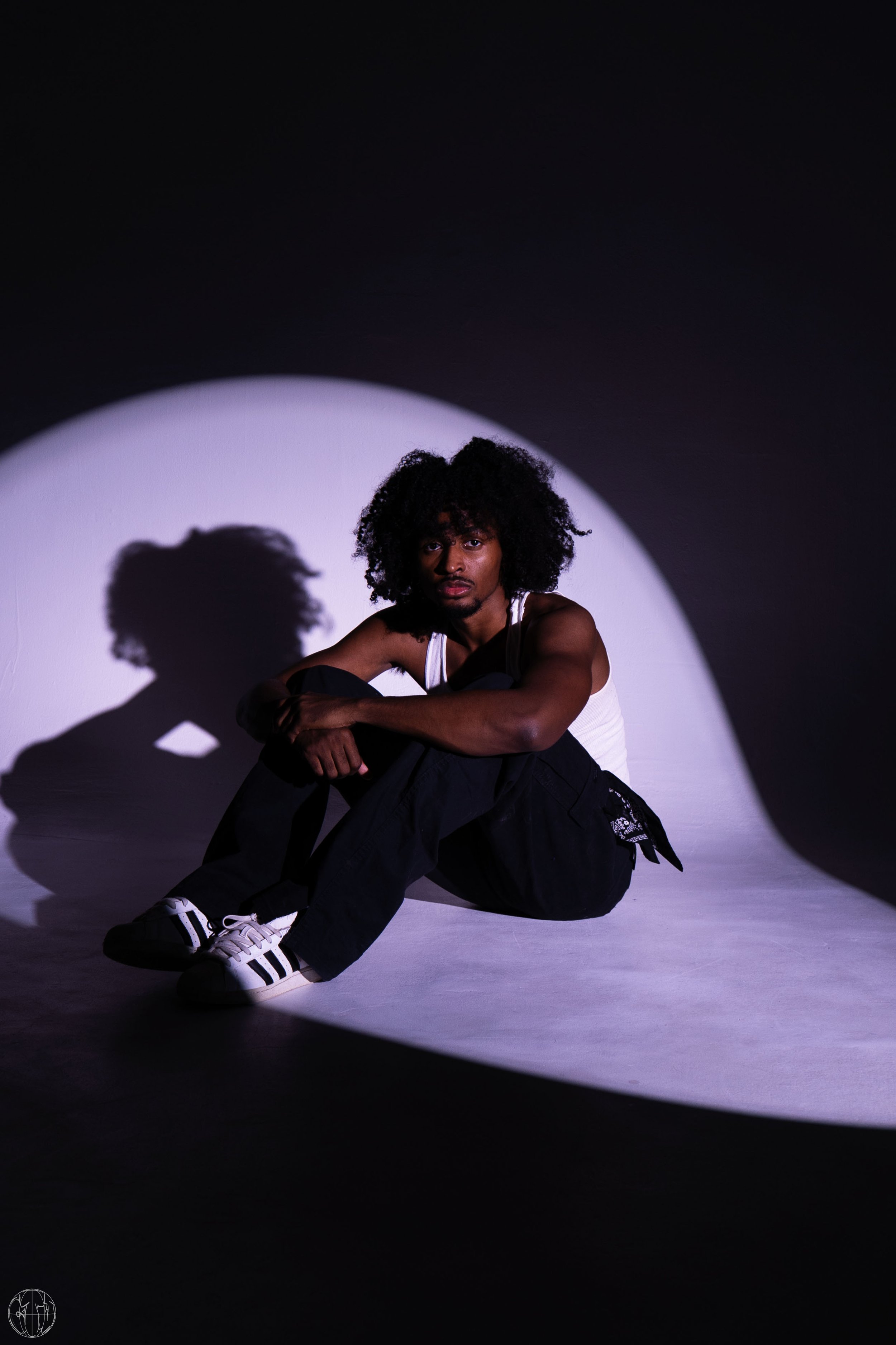 numbrs singer sitting down in stylized photo shoot. picture of numbrs for press.jpg