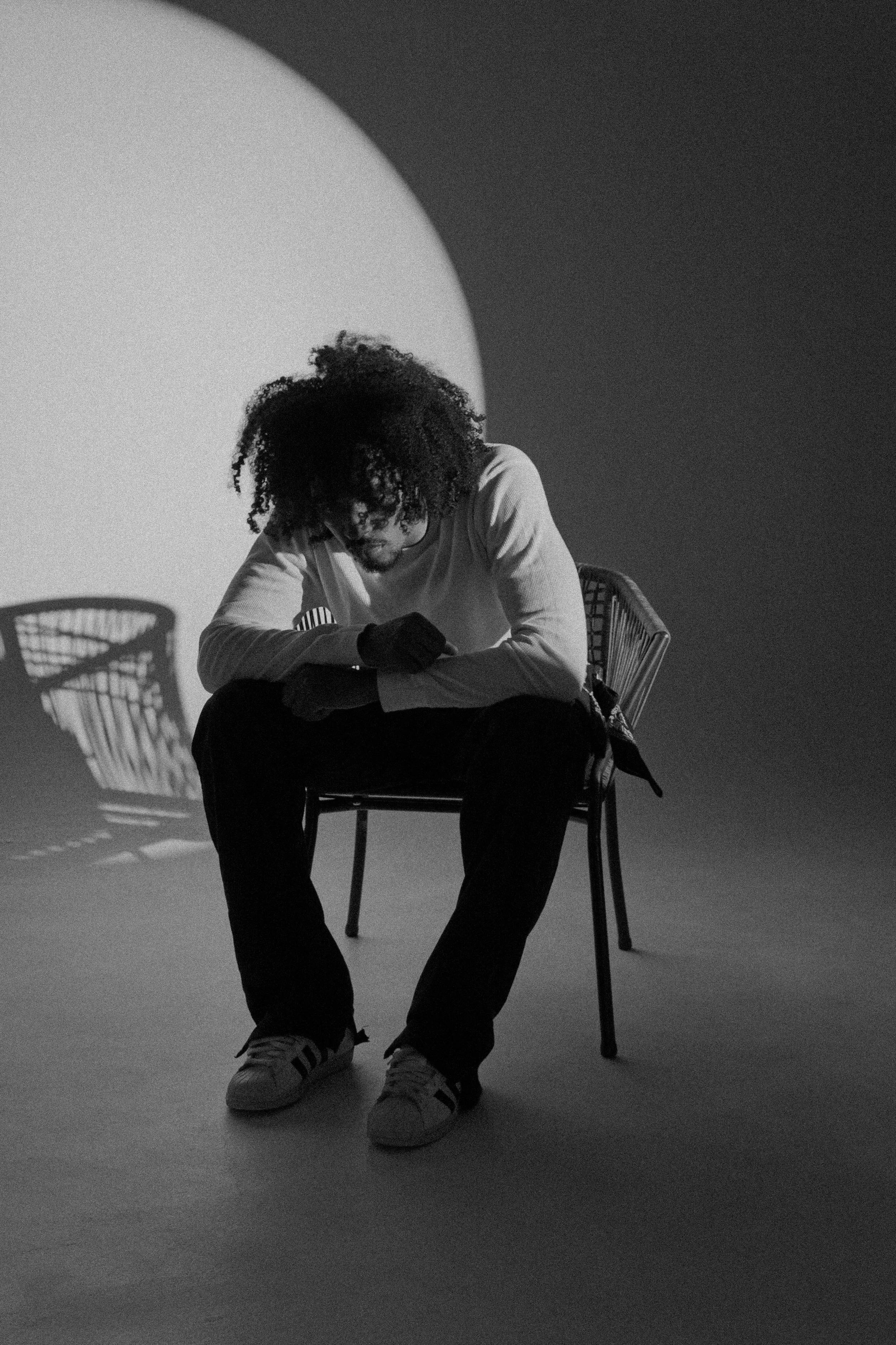numbrs artist looking down while sitting down in black and white.JPG