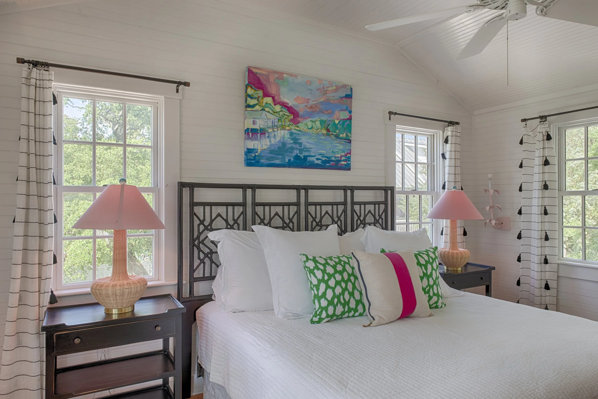 Primary bedroom at Bliss Cottage featuring a king-size bed, soft coastal bedding, and bright natural light, part of a layout that sleeps up to 10 guests.