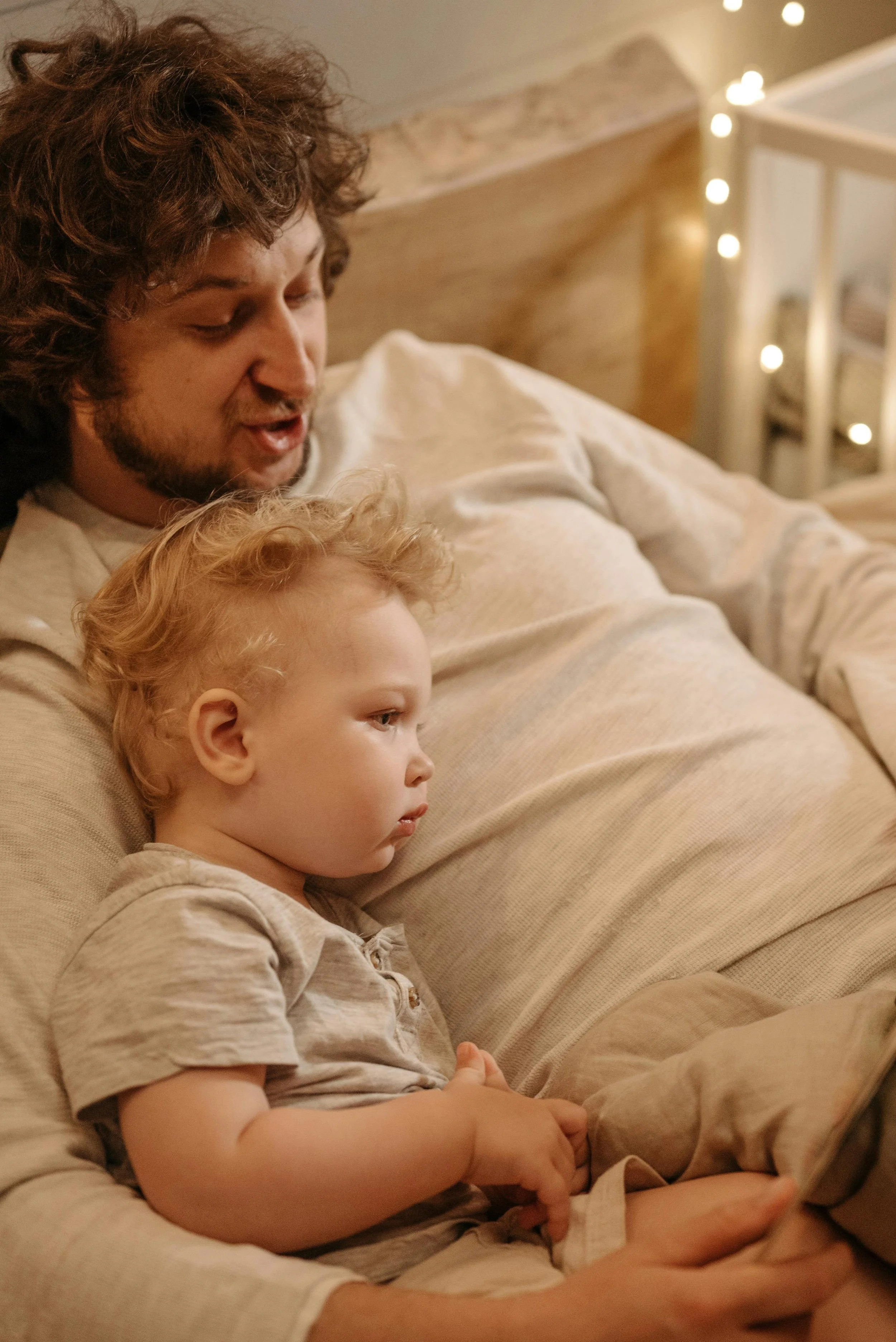 Father and son read books and sing songs before bed