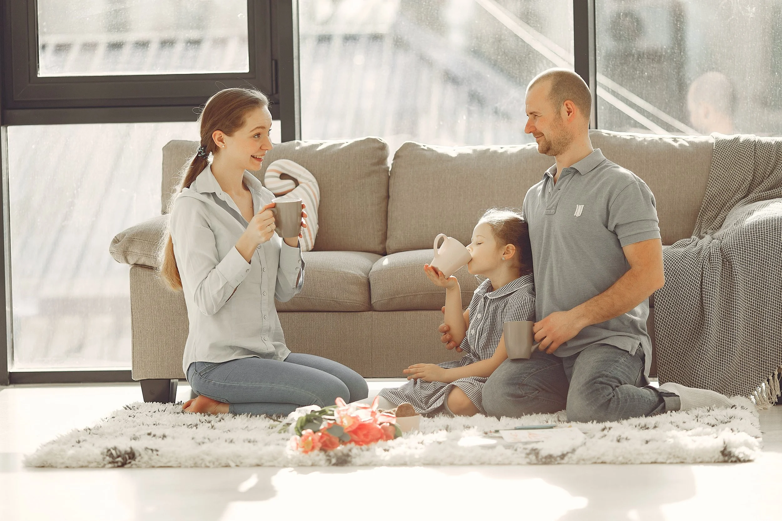 Mother spending time with her young children at home during an ordinary family moment.