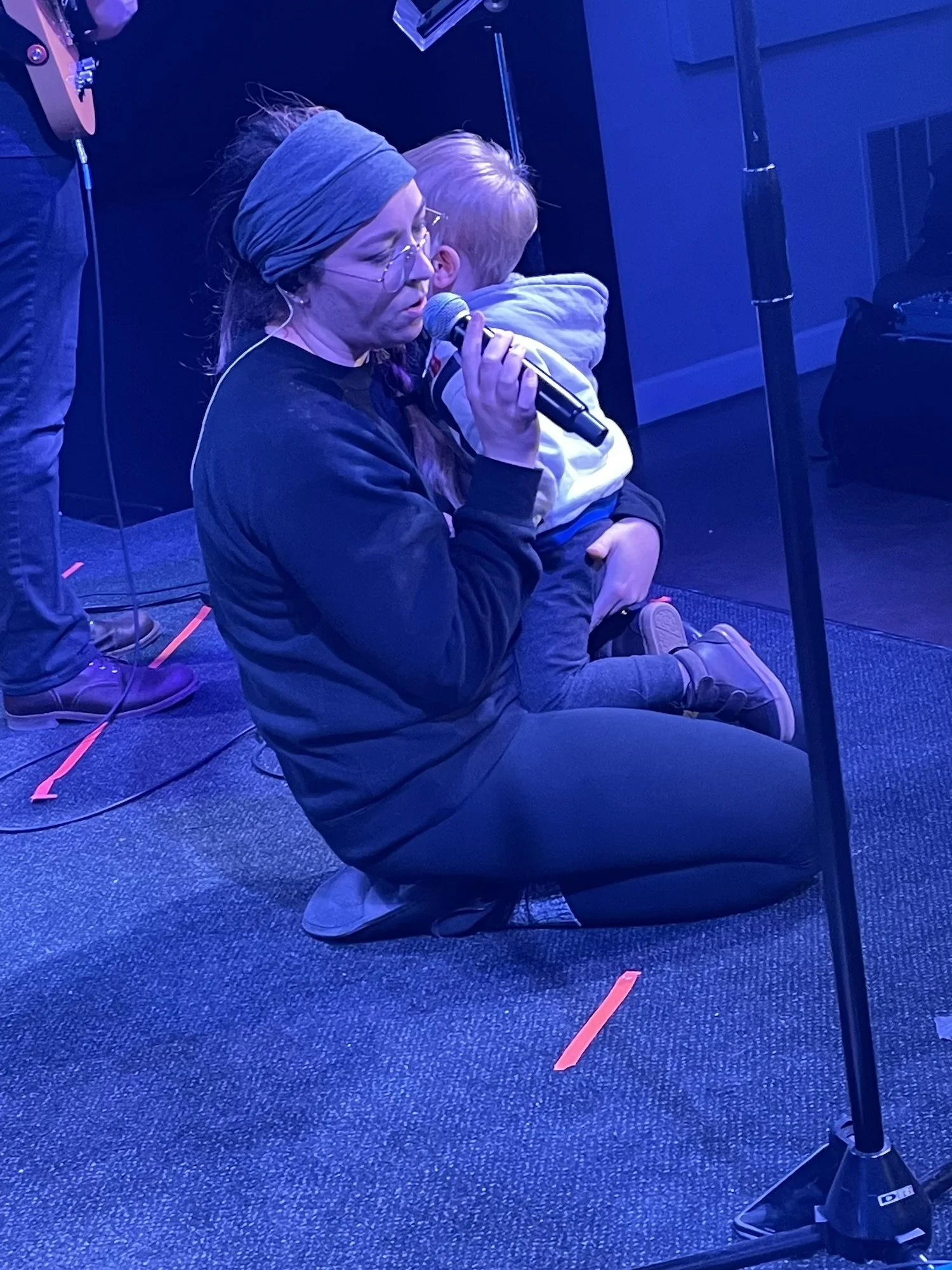 Mom worshipping with son at church peaceful worship family rhythms