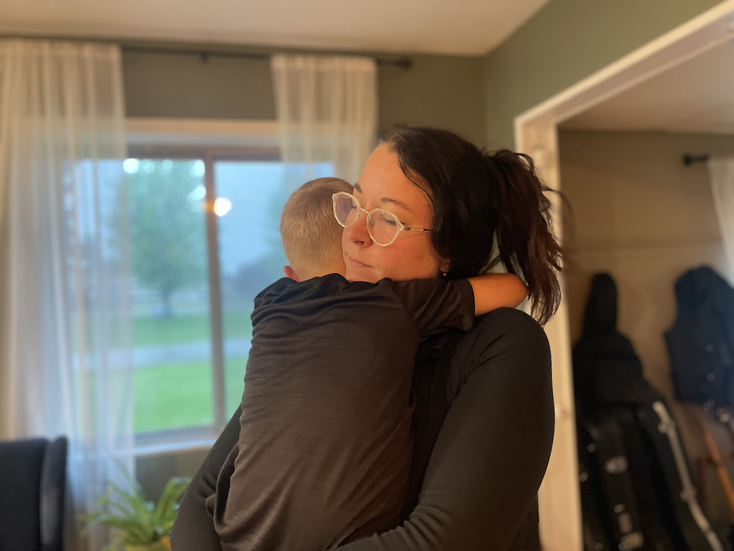 Mother worshipping with her young son in a peaceful home setting, creating a faith-filled atmosphere through worship and connection.