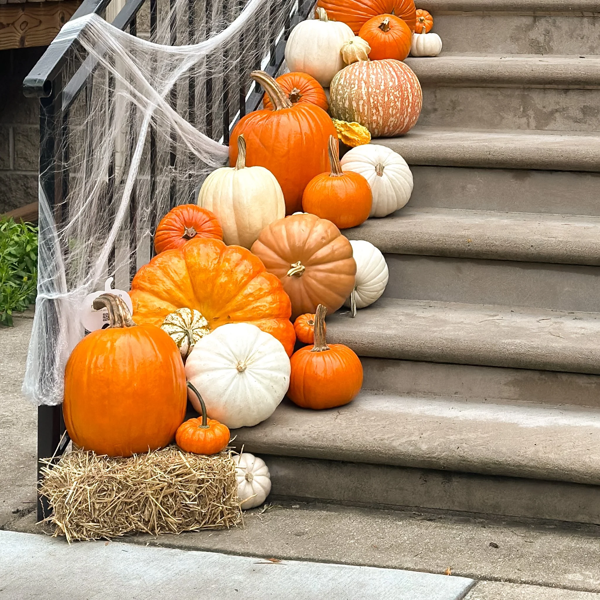 straw bales in a porch pumpkin display.jpg