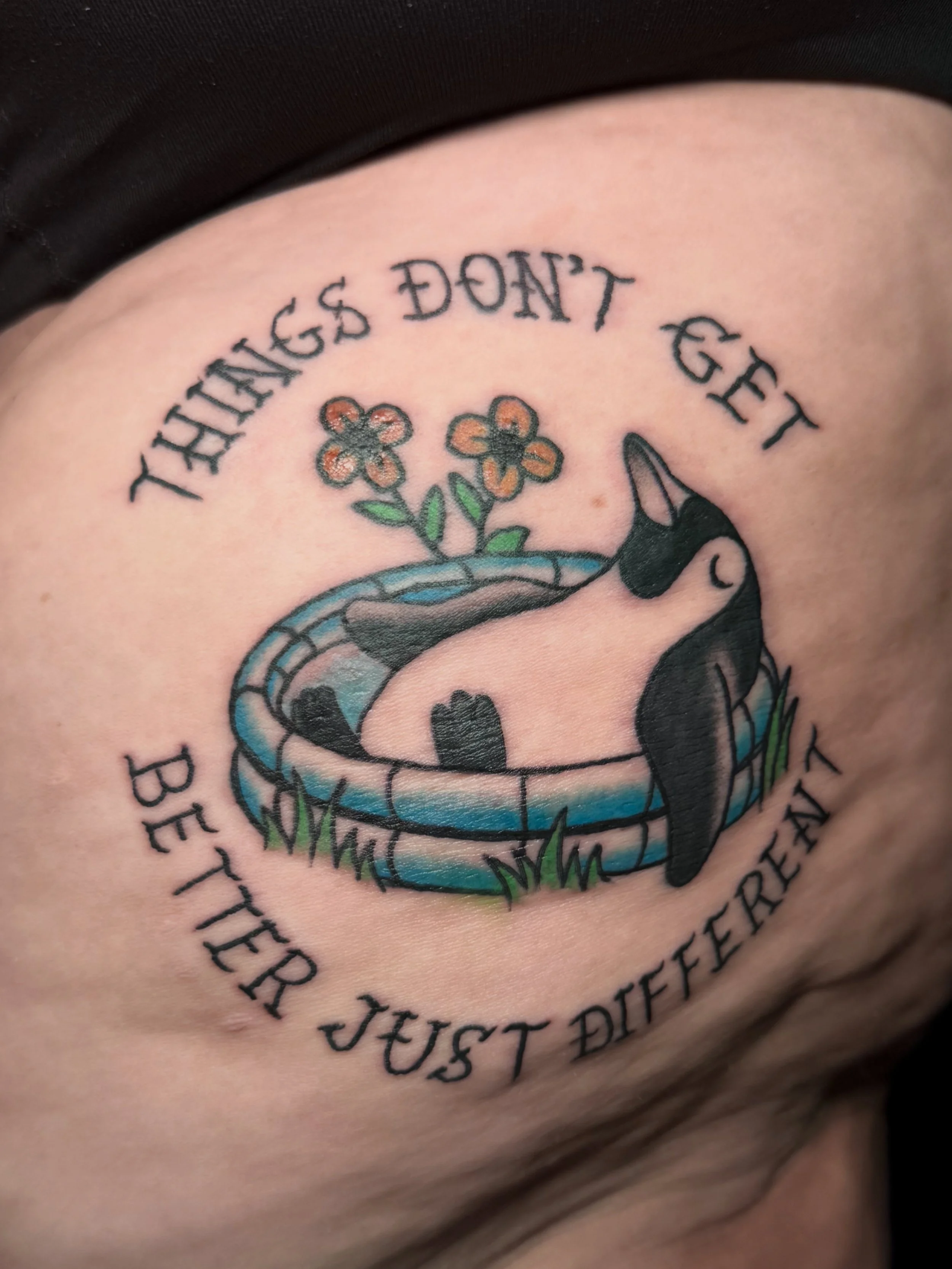 Tattoo with a snake, flowers, and a Bible verse