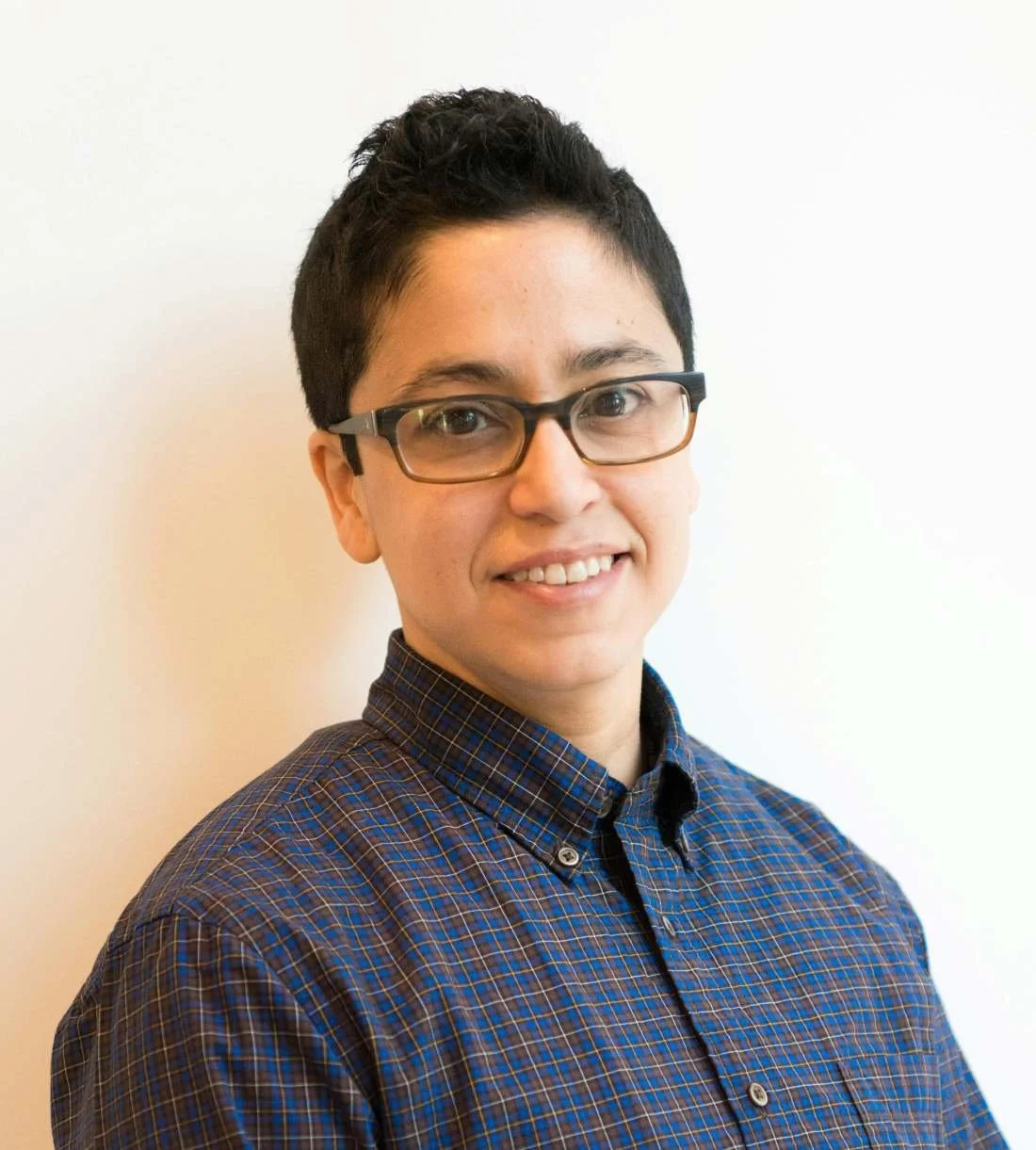 non-binary-person-in-their-30s-smiling